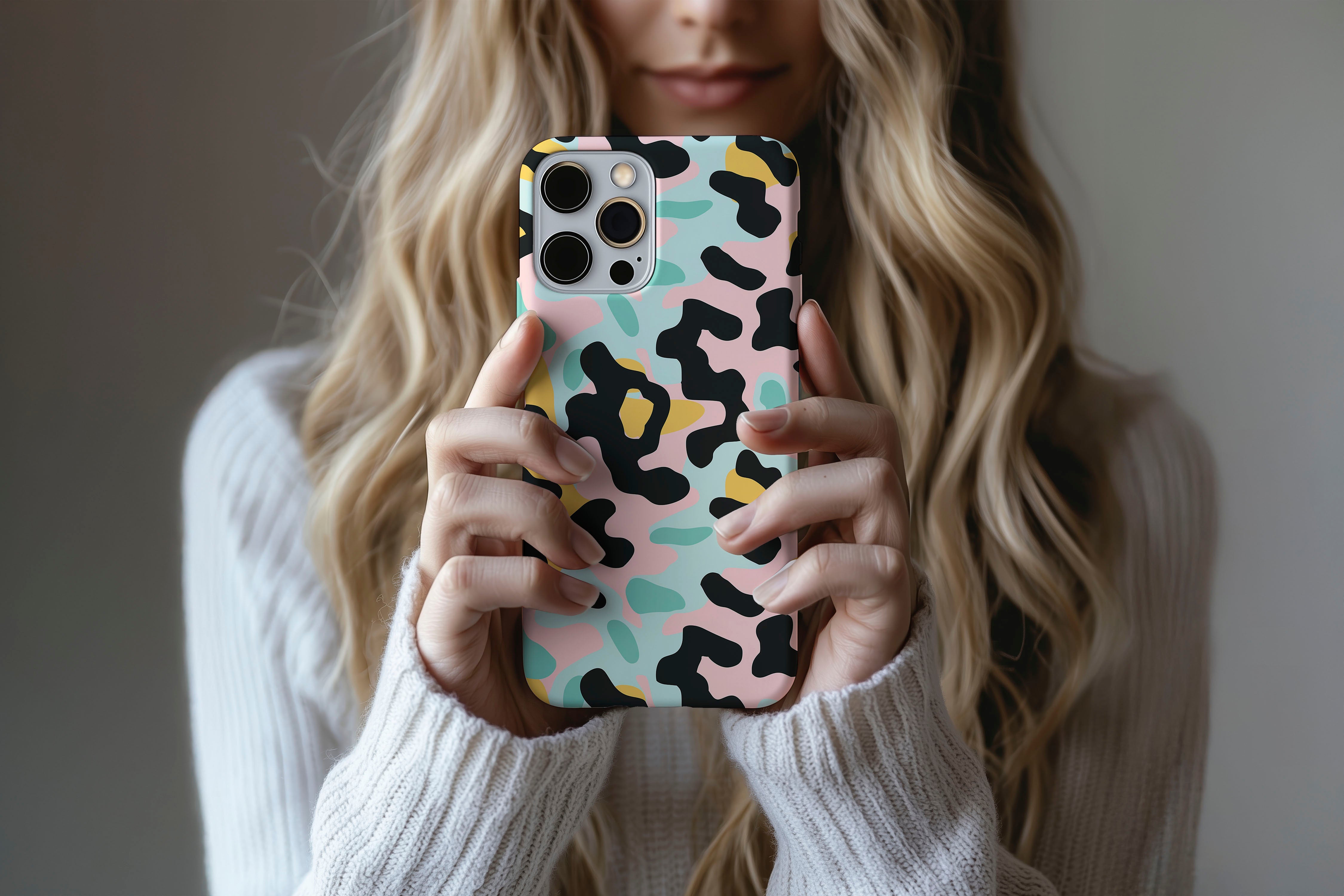 A cute girl holding a phone case featuring our 80S Camo Cool design