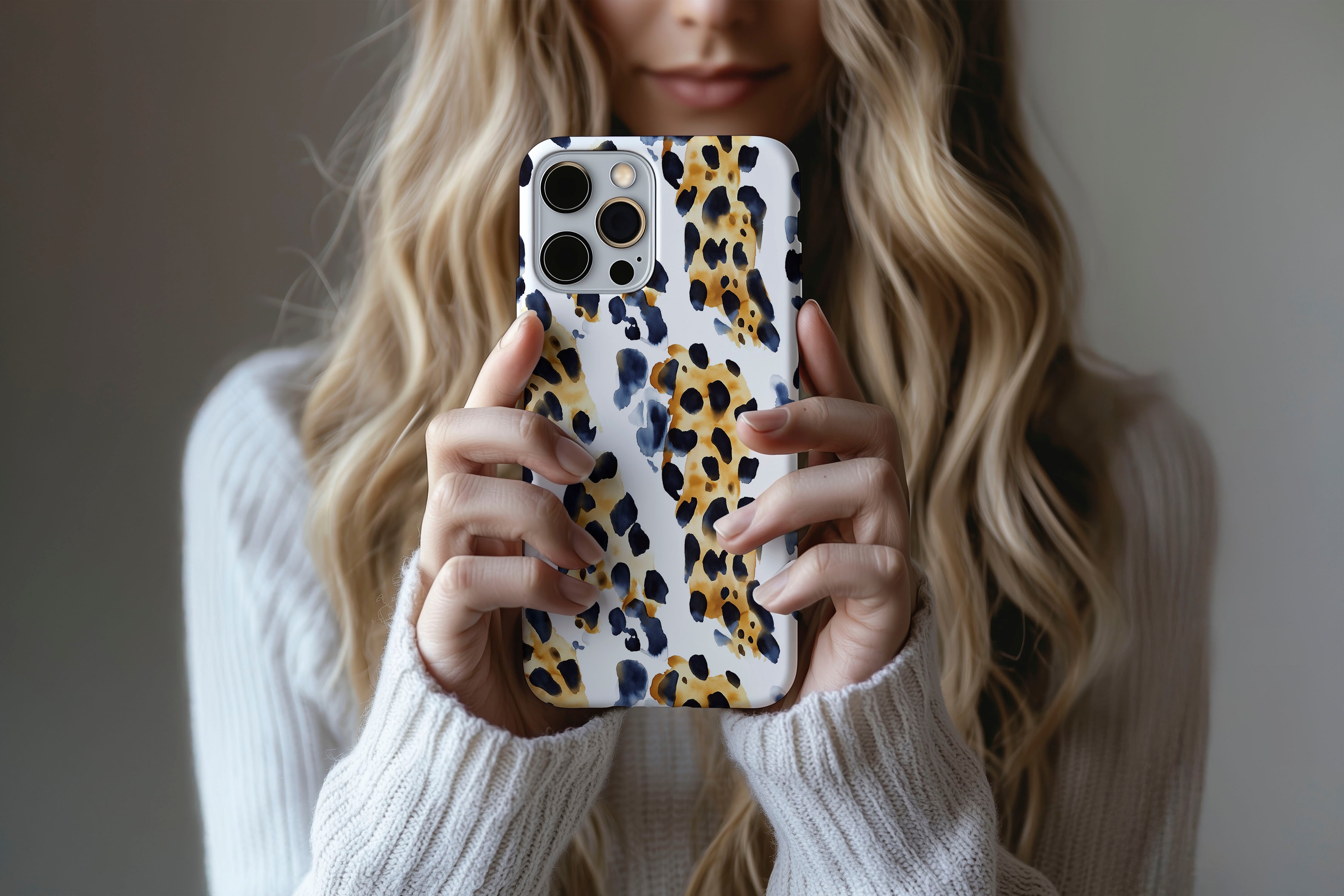 A cute girl holding a phone case featuring our Abstract Leopard design