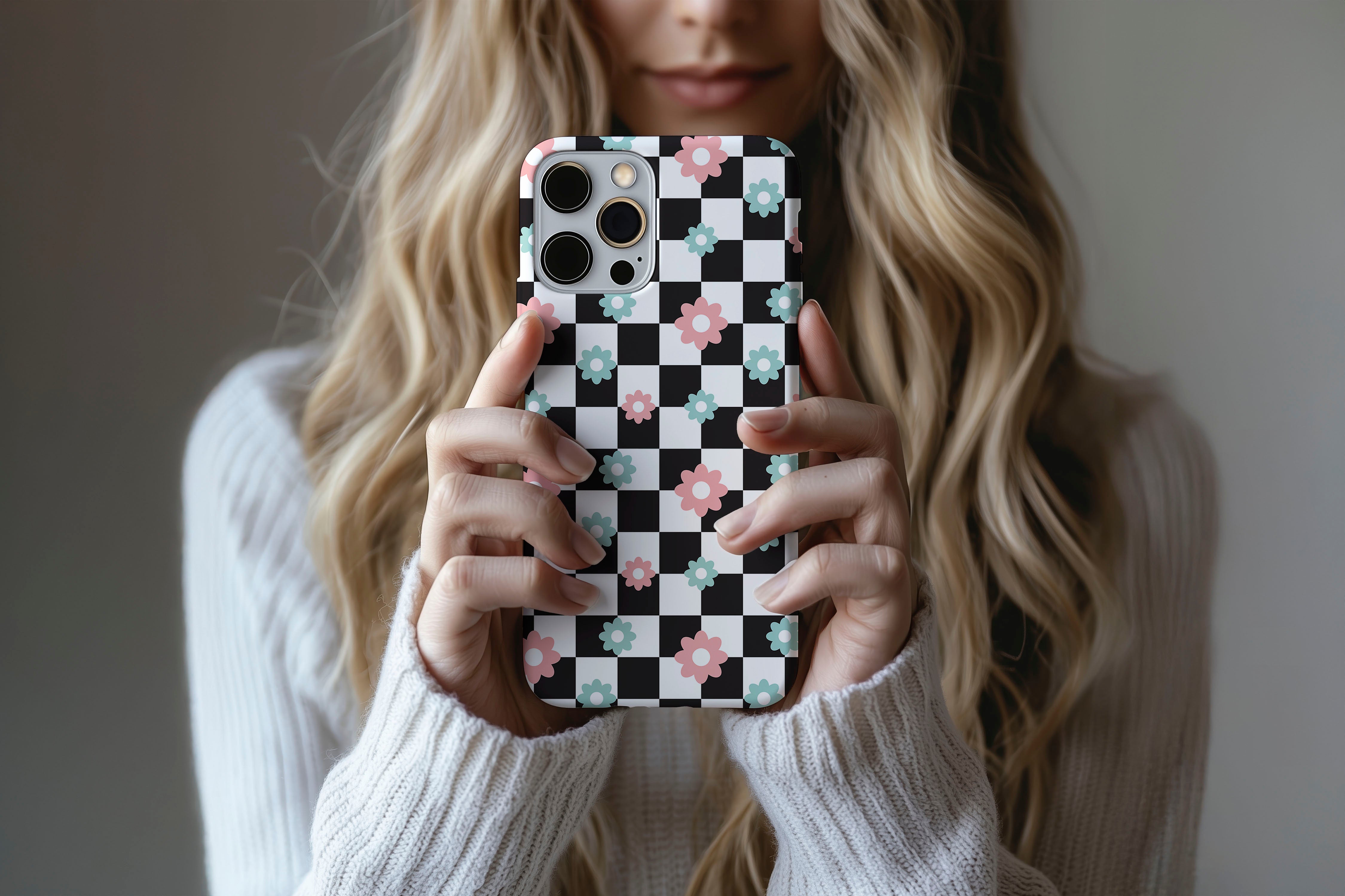 A cute girl holding a phone case featuring our Check Flower design