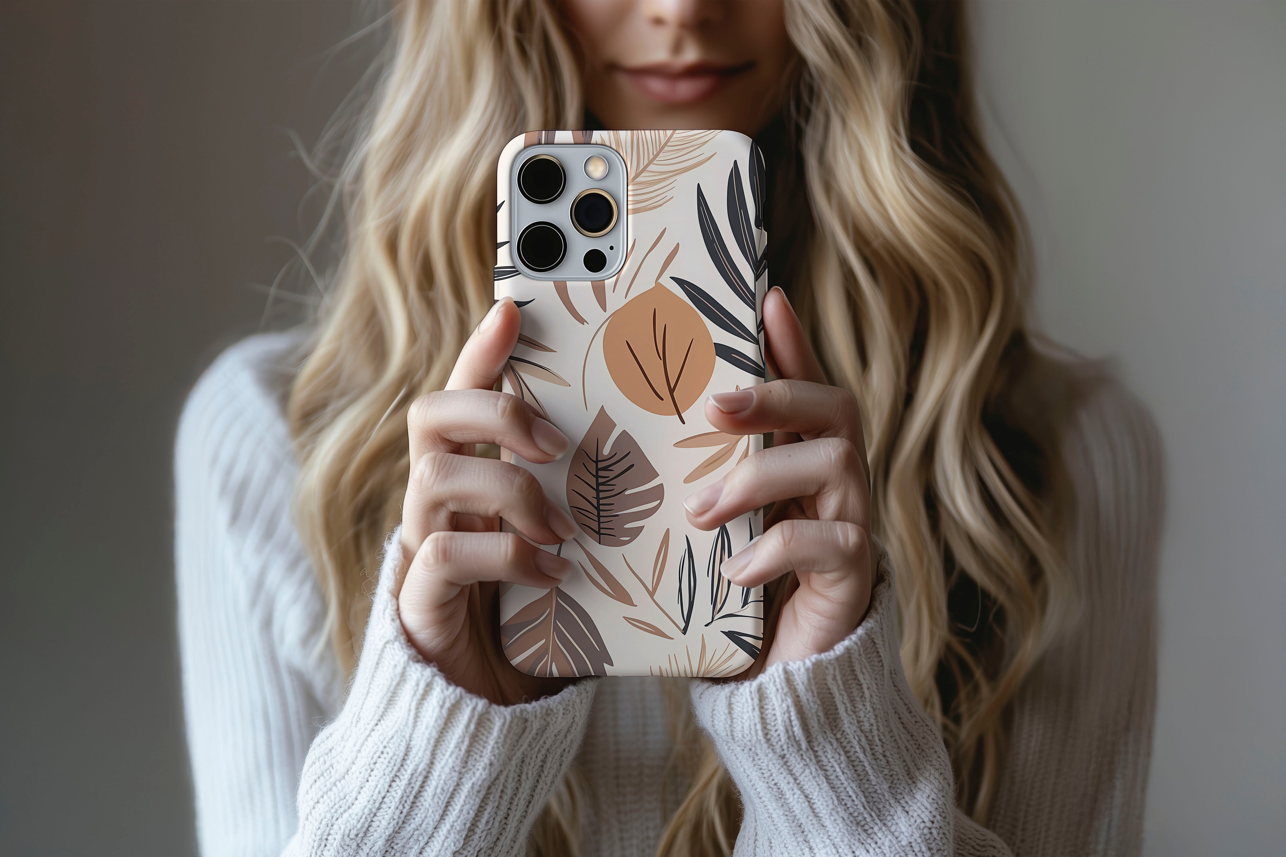 A cute girl holding a phone case featuring our Nude Leaf design