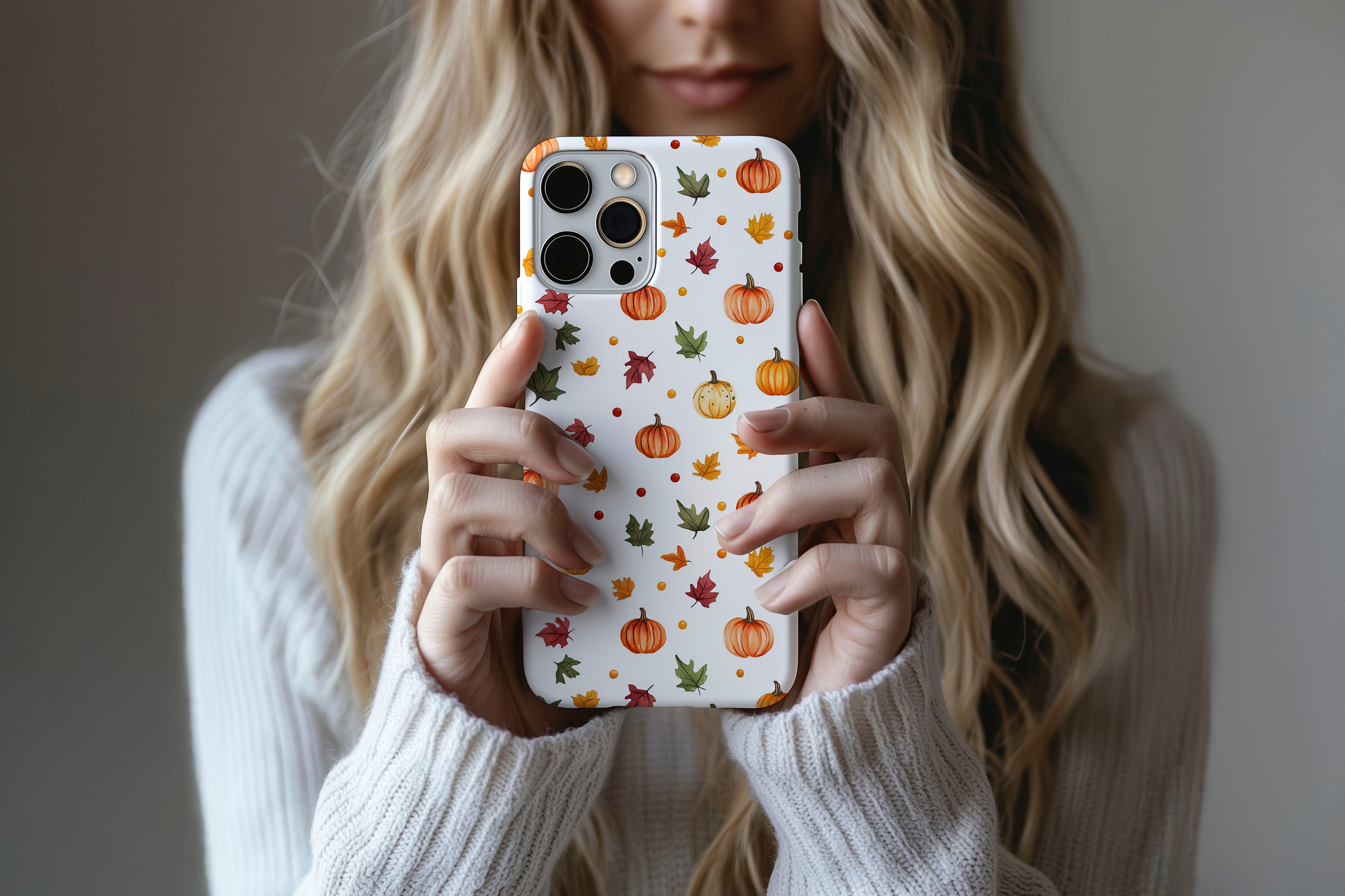 A cute girl holding a phone case featuring our Pumpkins design