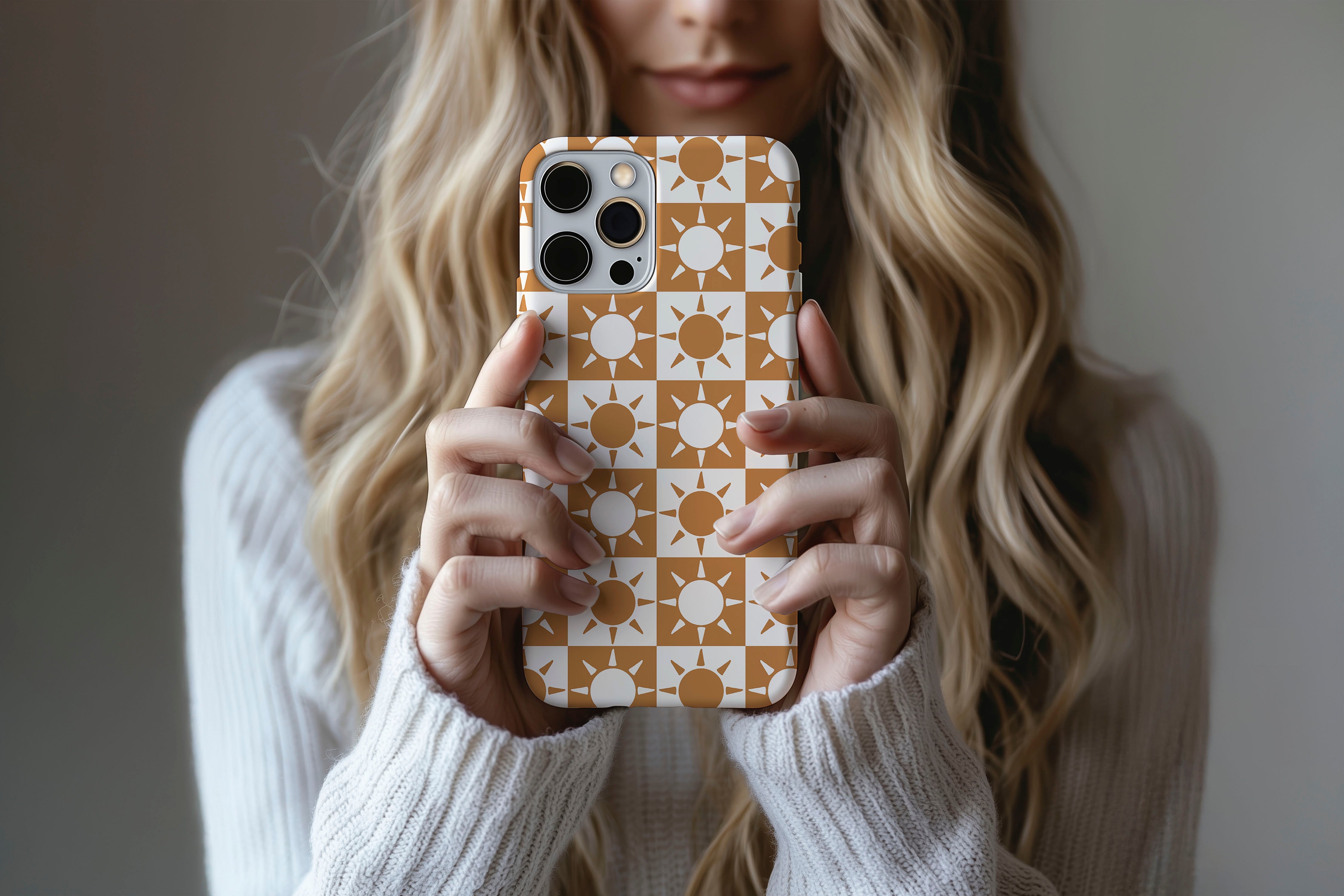 A cute girl holding a phone case featuring our Sun design