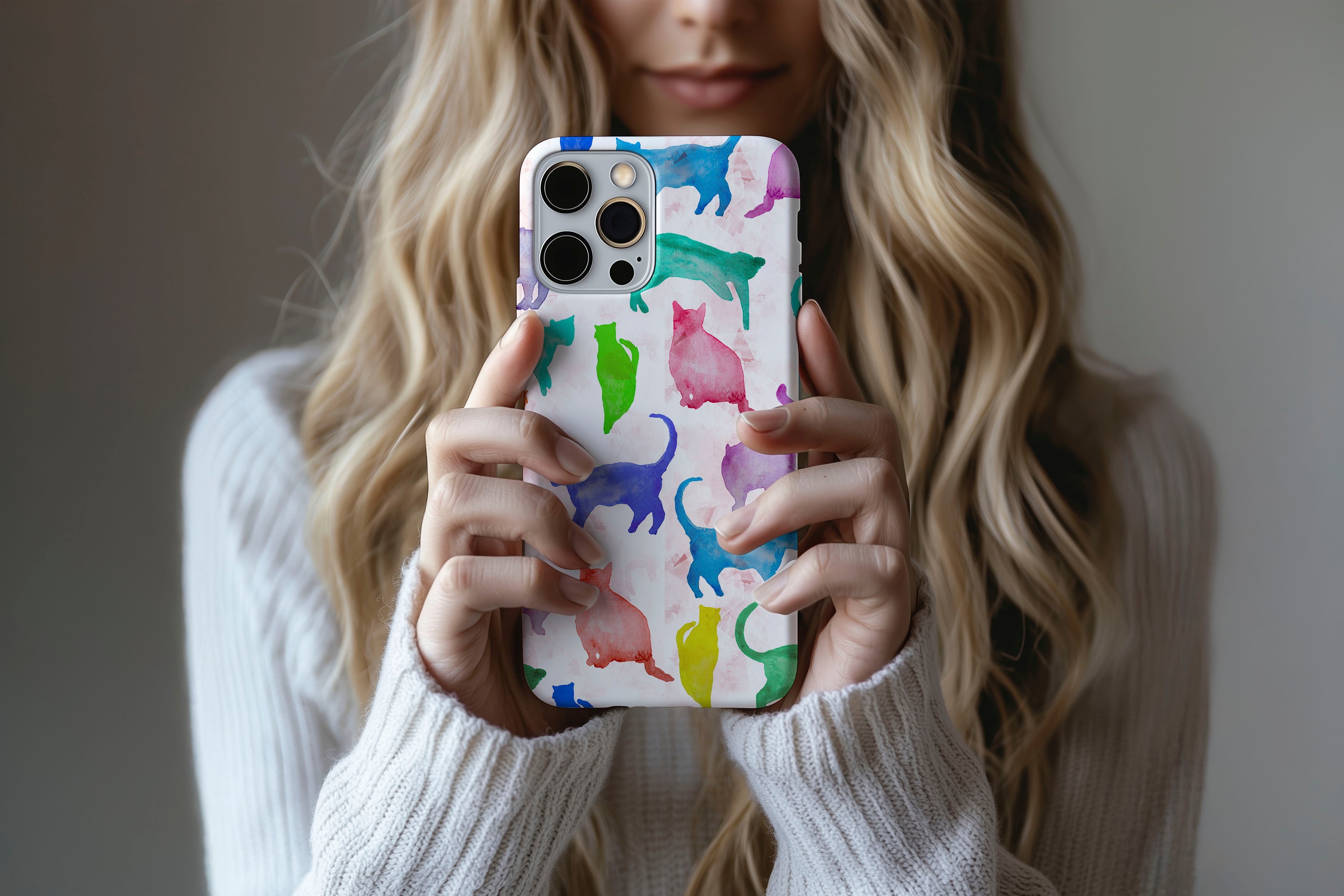 A cute girl holding a phone case featuring our Abstract Cats design