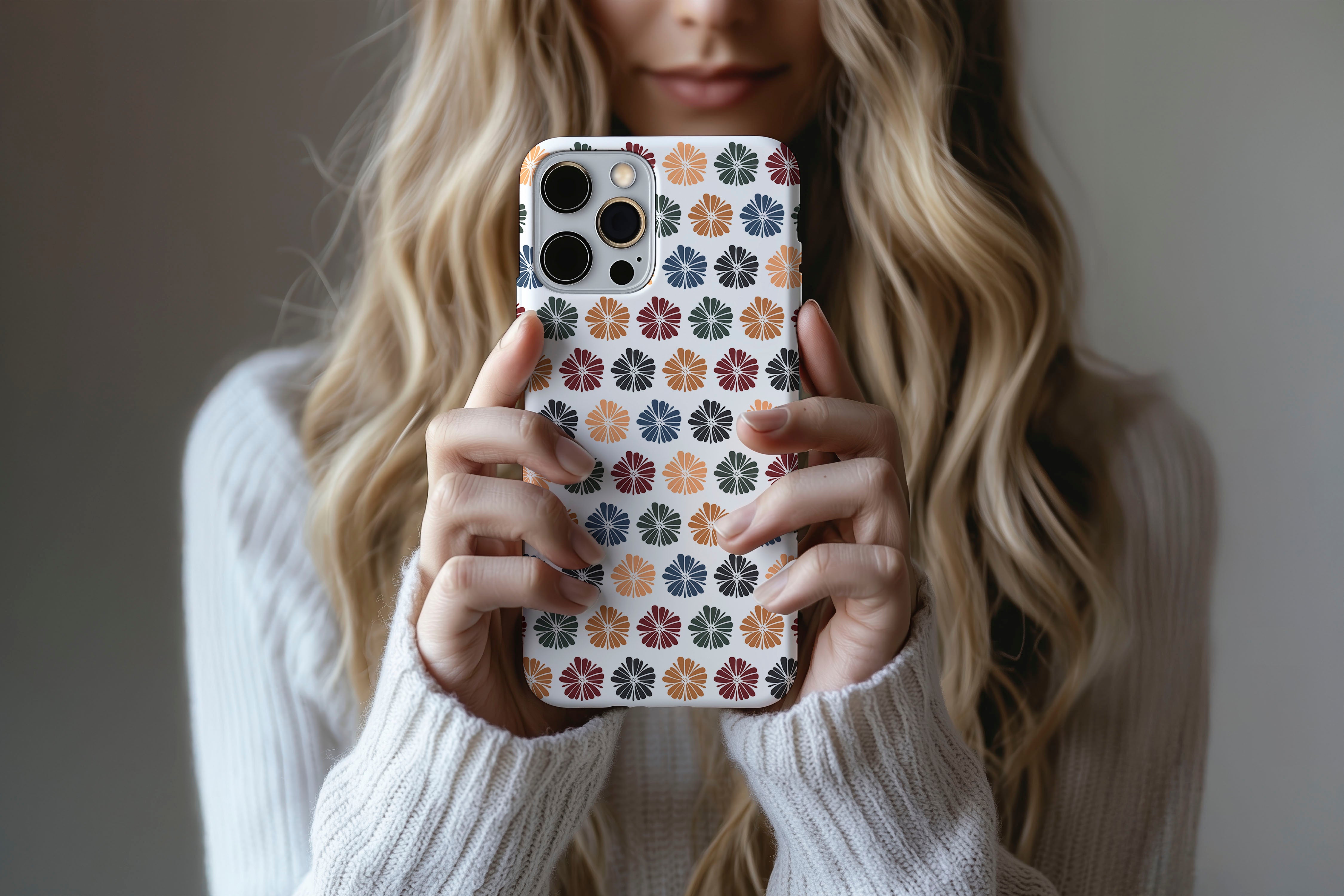 A cute girl holding a phone case featuring our Autumn Floral design