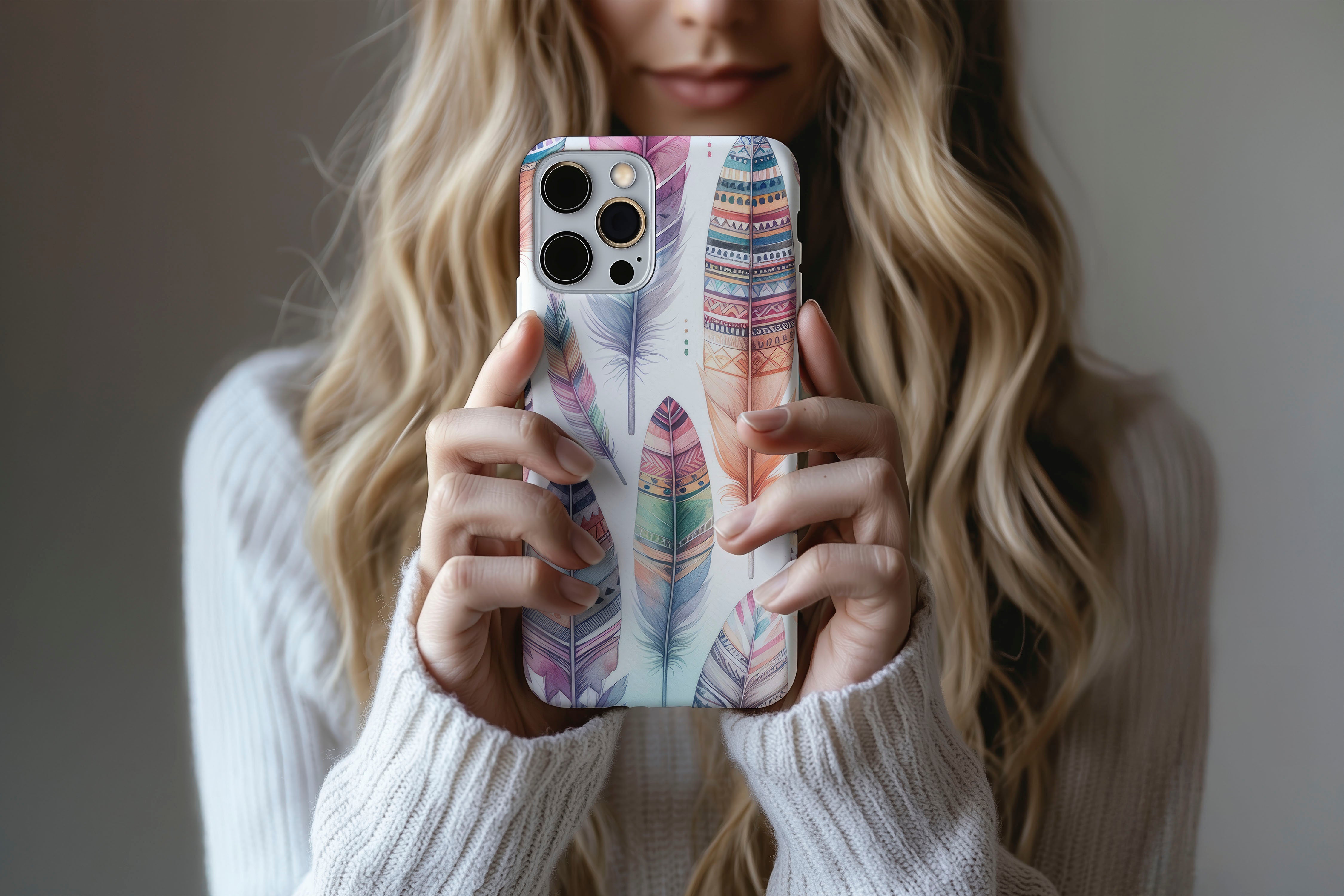 A cute girl holding a phone case featuring our Big Feather design