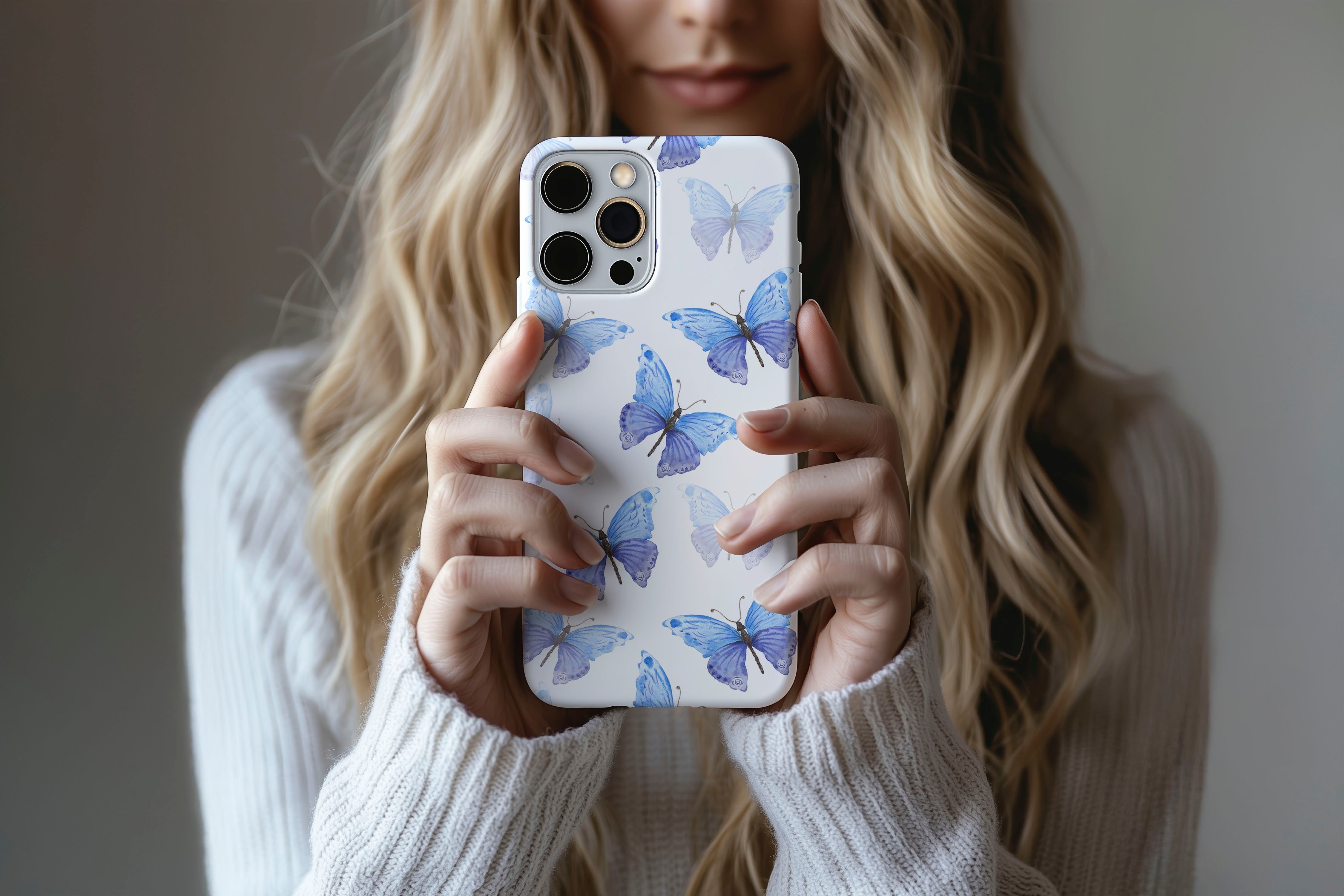 A cute girl holding a phone case featuring our Blue Butterfly design