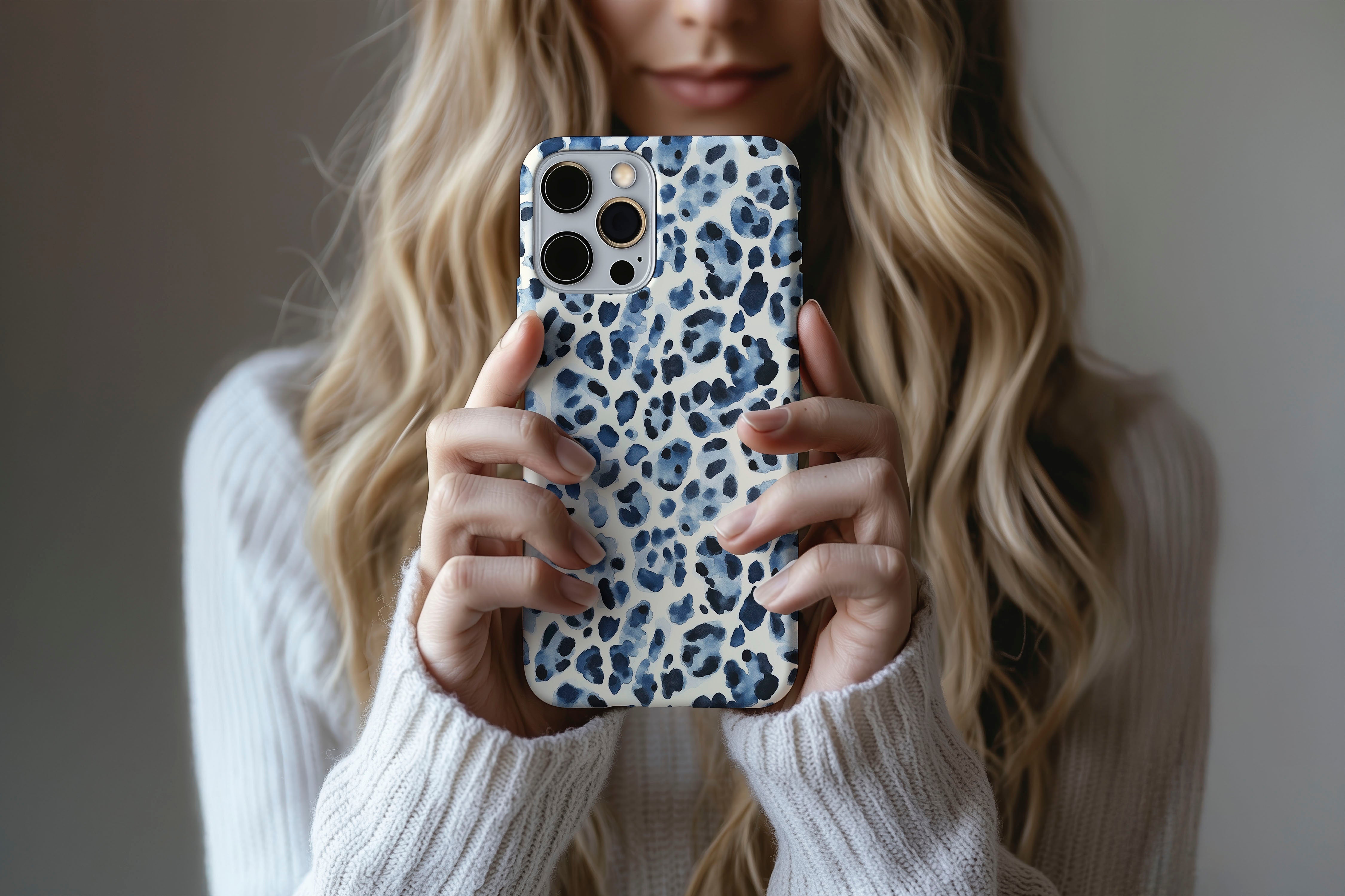 A cute girl holding a phone case featuring our Blue Leopard design