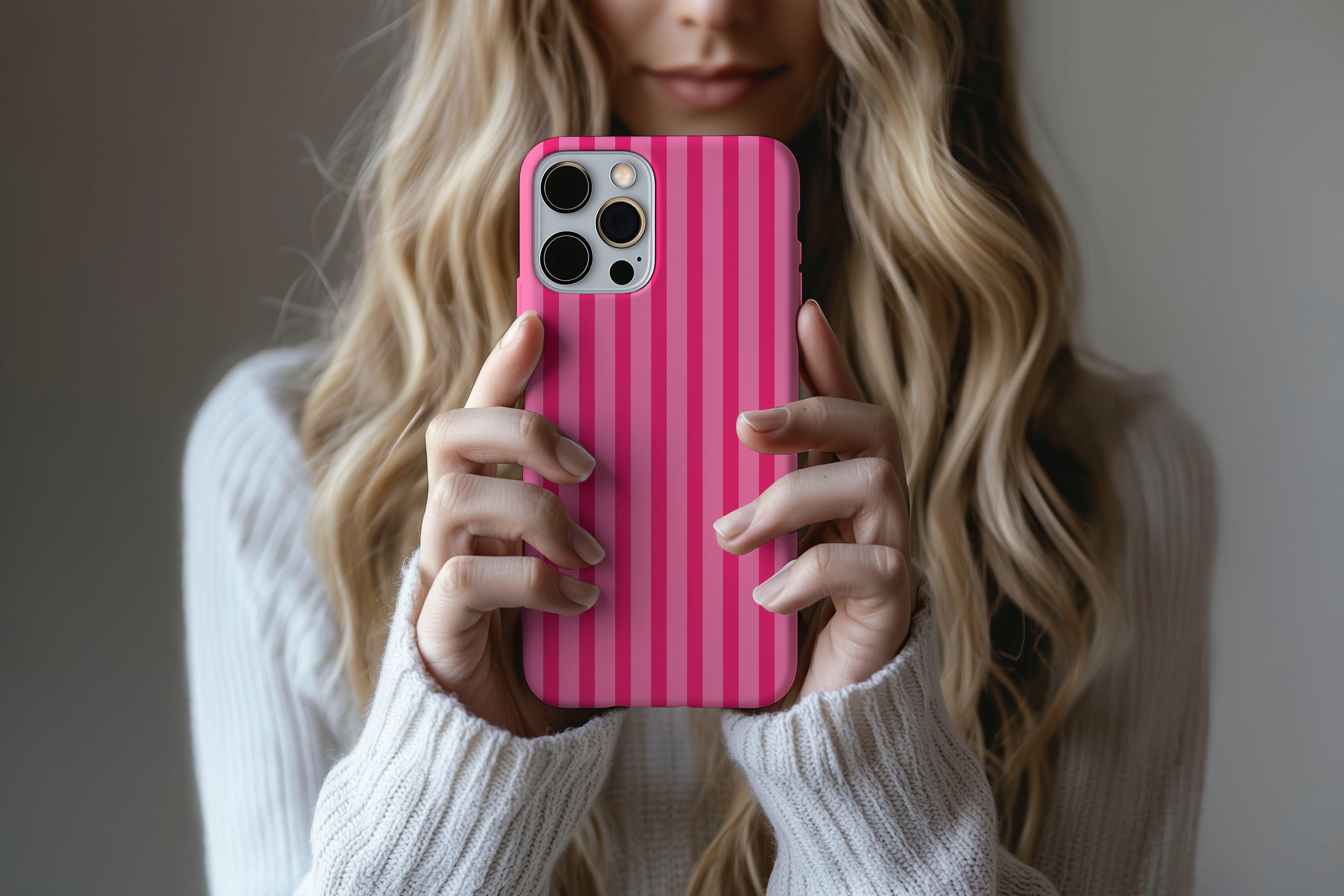 A cute girl holding a phone case featuring our Candy Stripe design