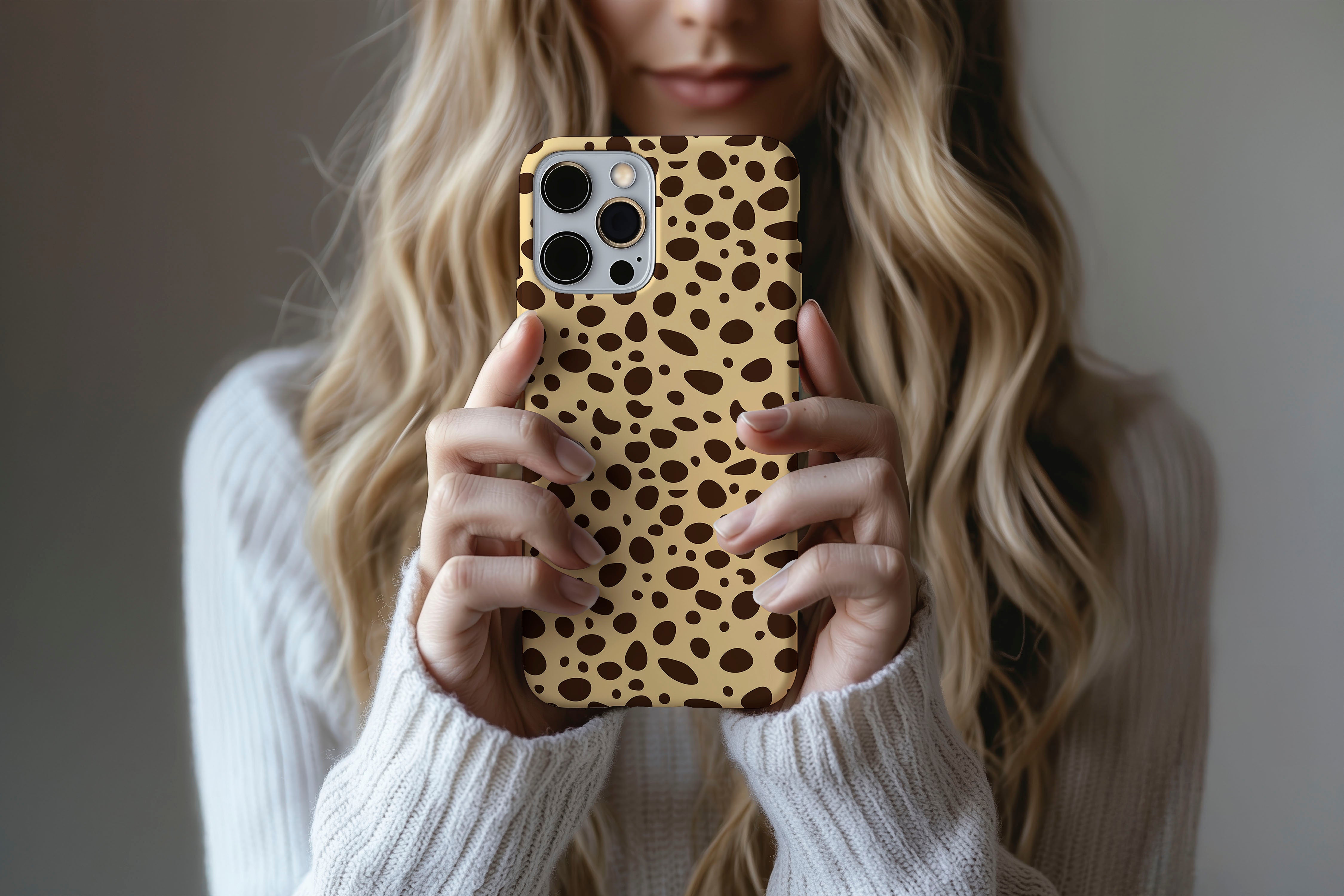 A cute girl holding a phone case featuring our Cheetah Cheetah design