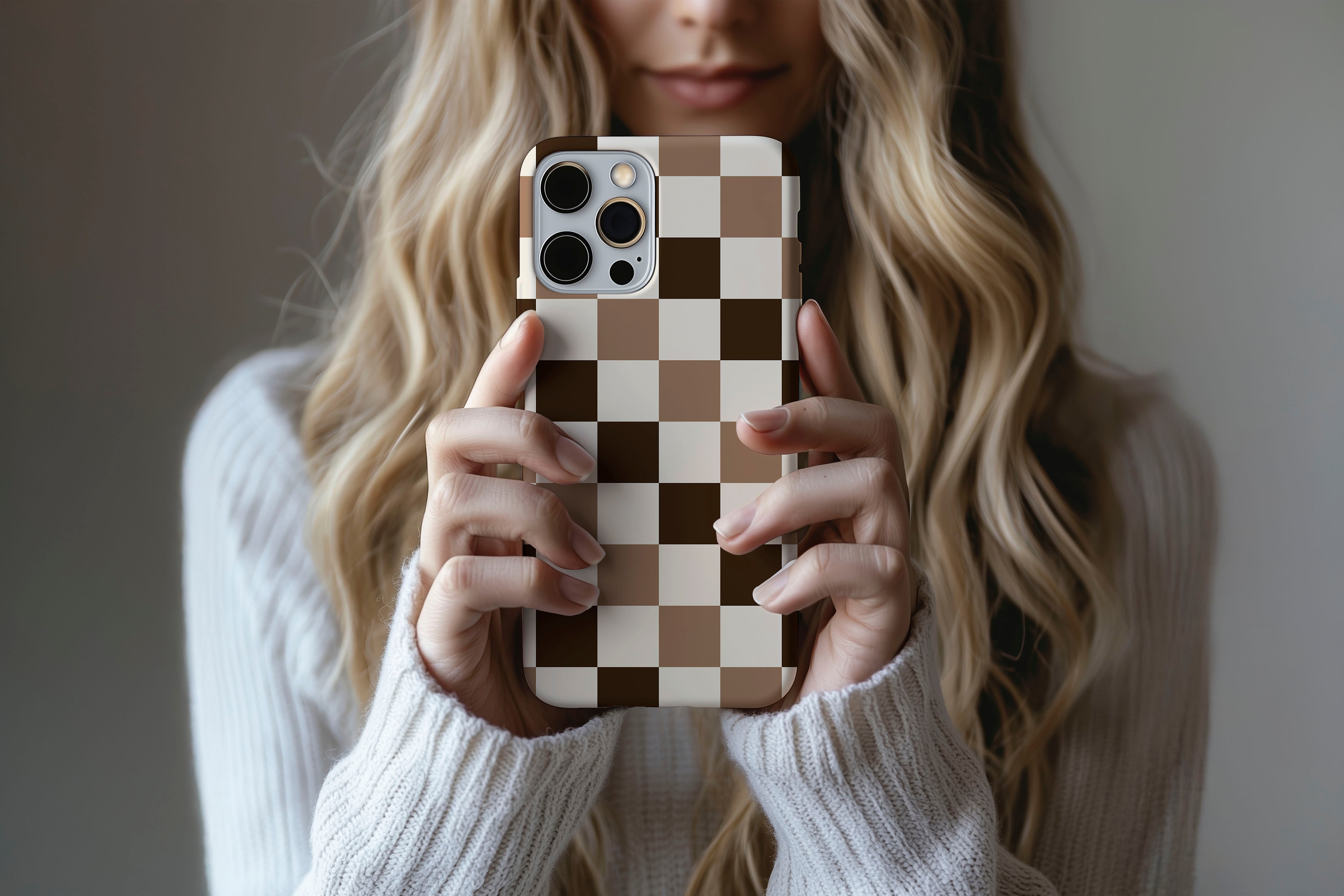 A cute girl holding a phone case featuring our Chocolate Check design