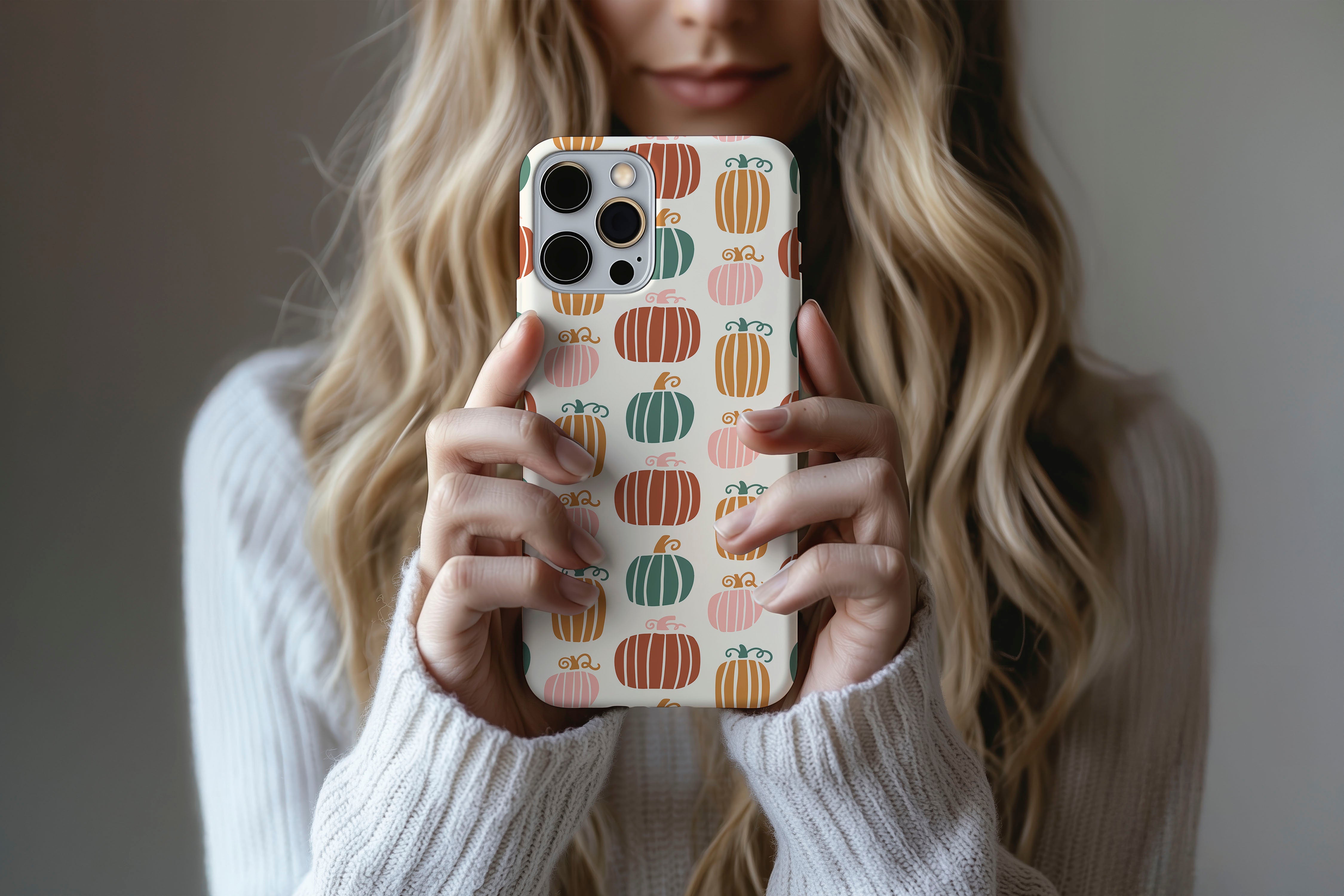 A cute girl holding a phone case featuring our Cool Pumpkin design