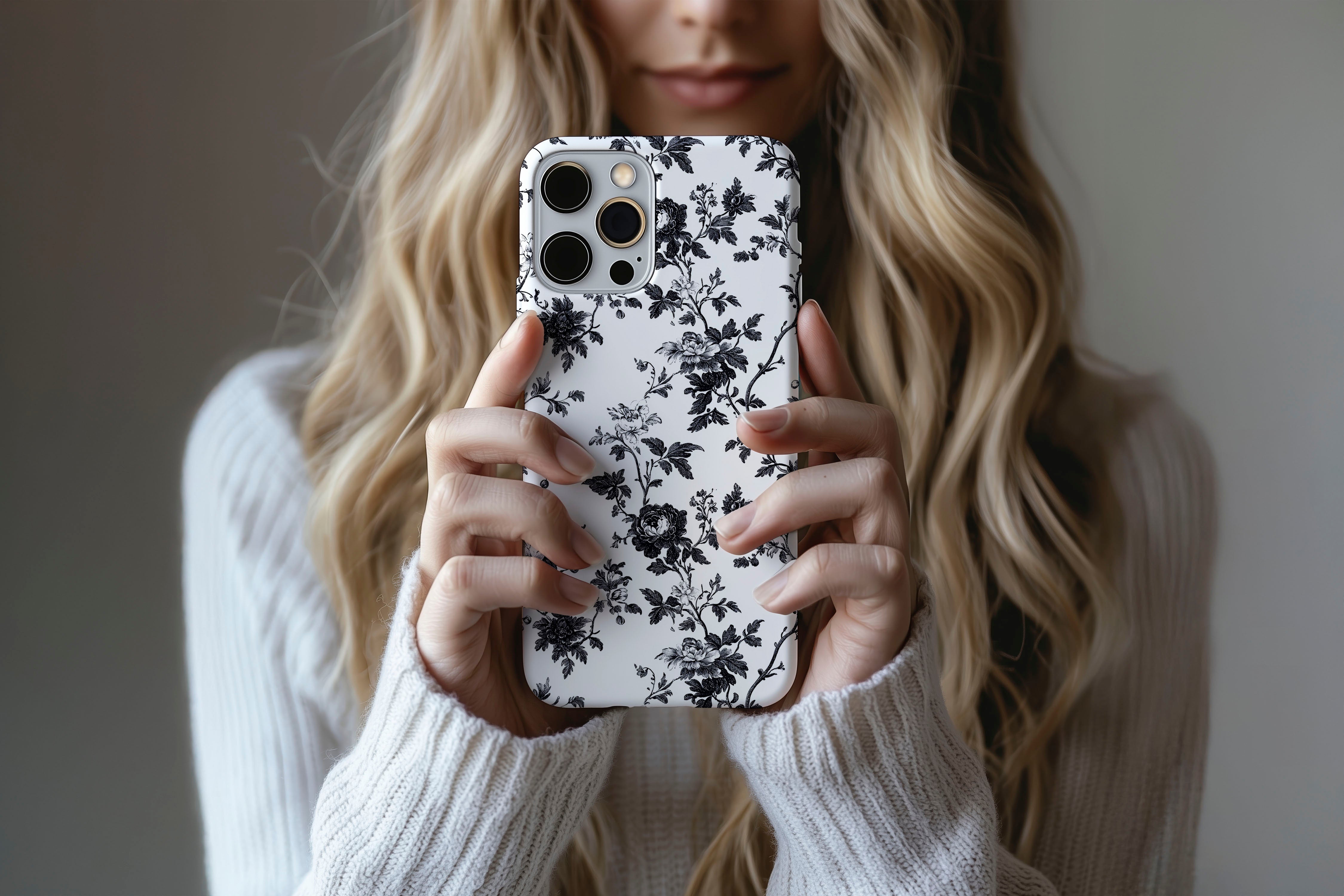 A cute girl holding a phone case featuring our Dark Rose design