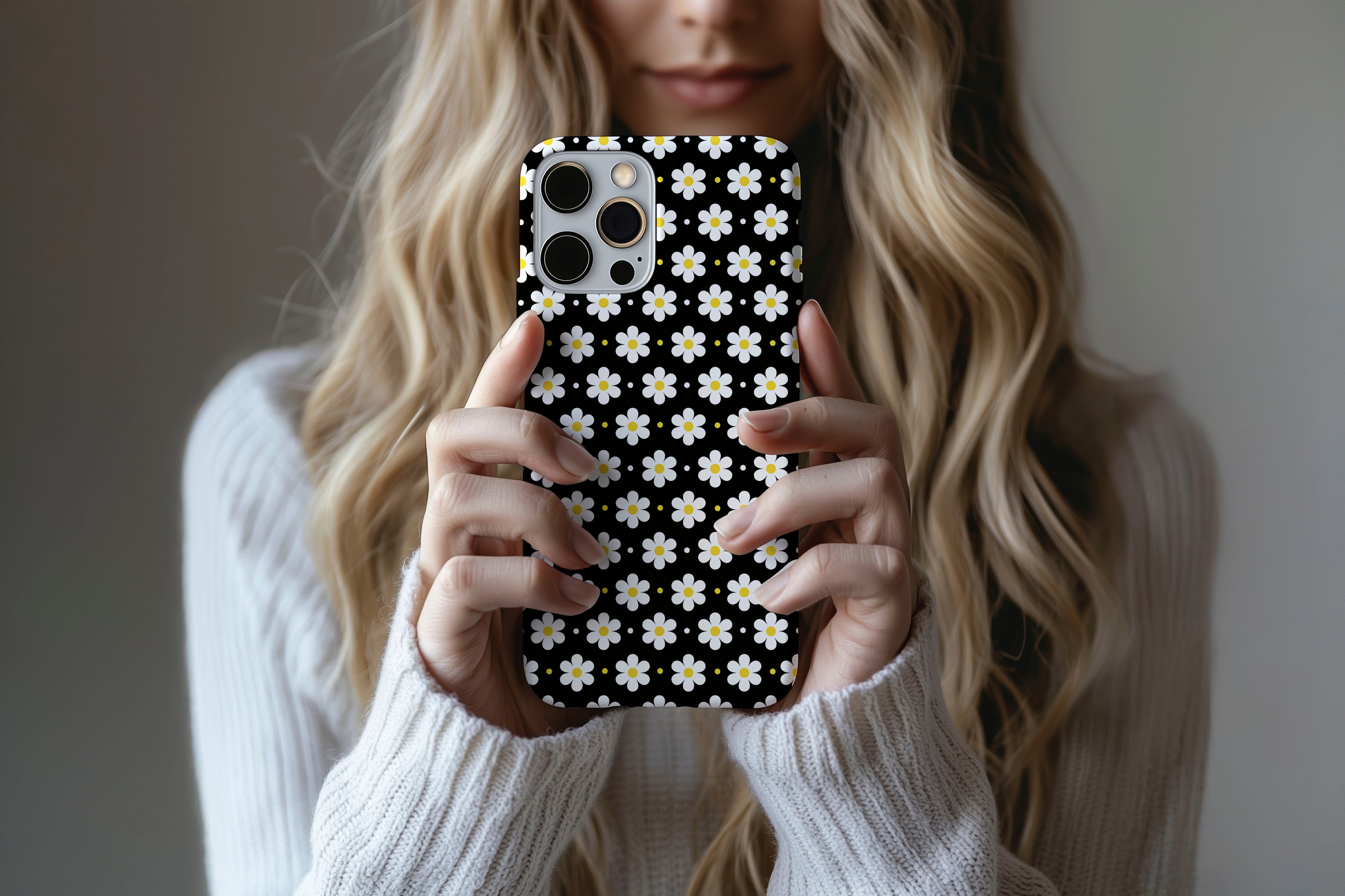 A cute girl holding a phone case featuring our Ditsy Daisy design