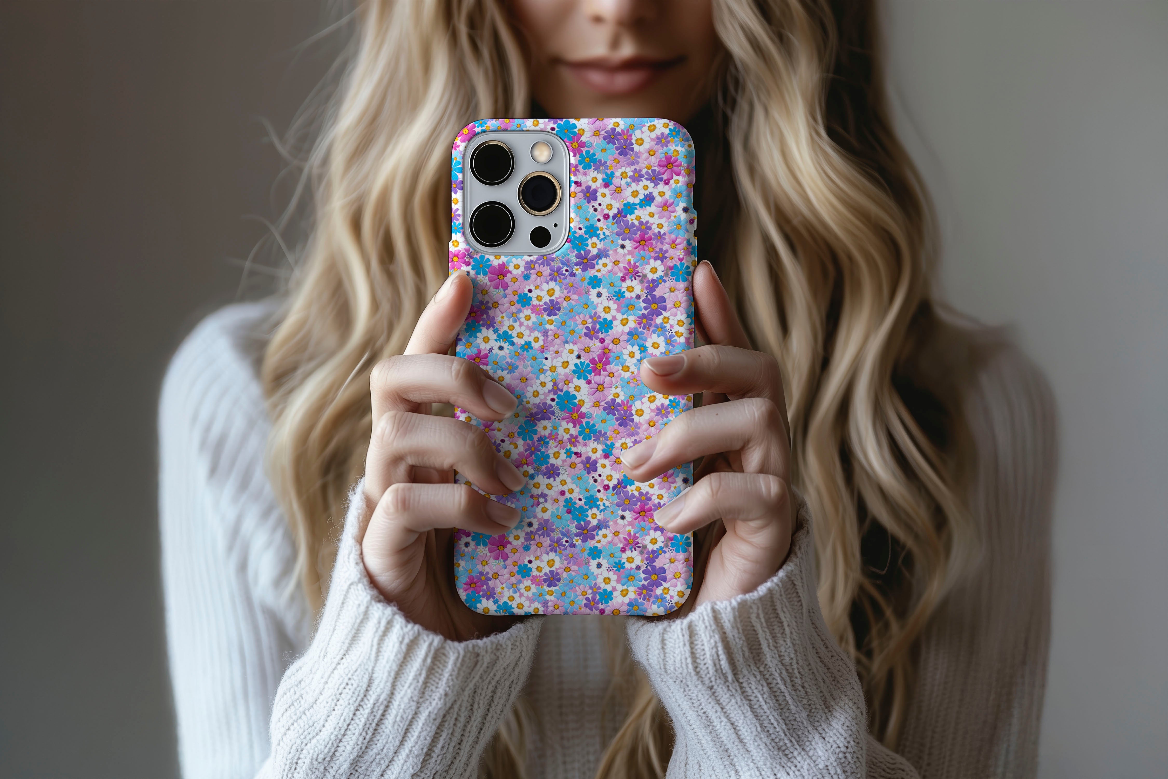 A cute girl holding a phone case featuring our Duke Daisy design