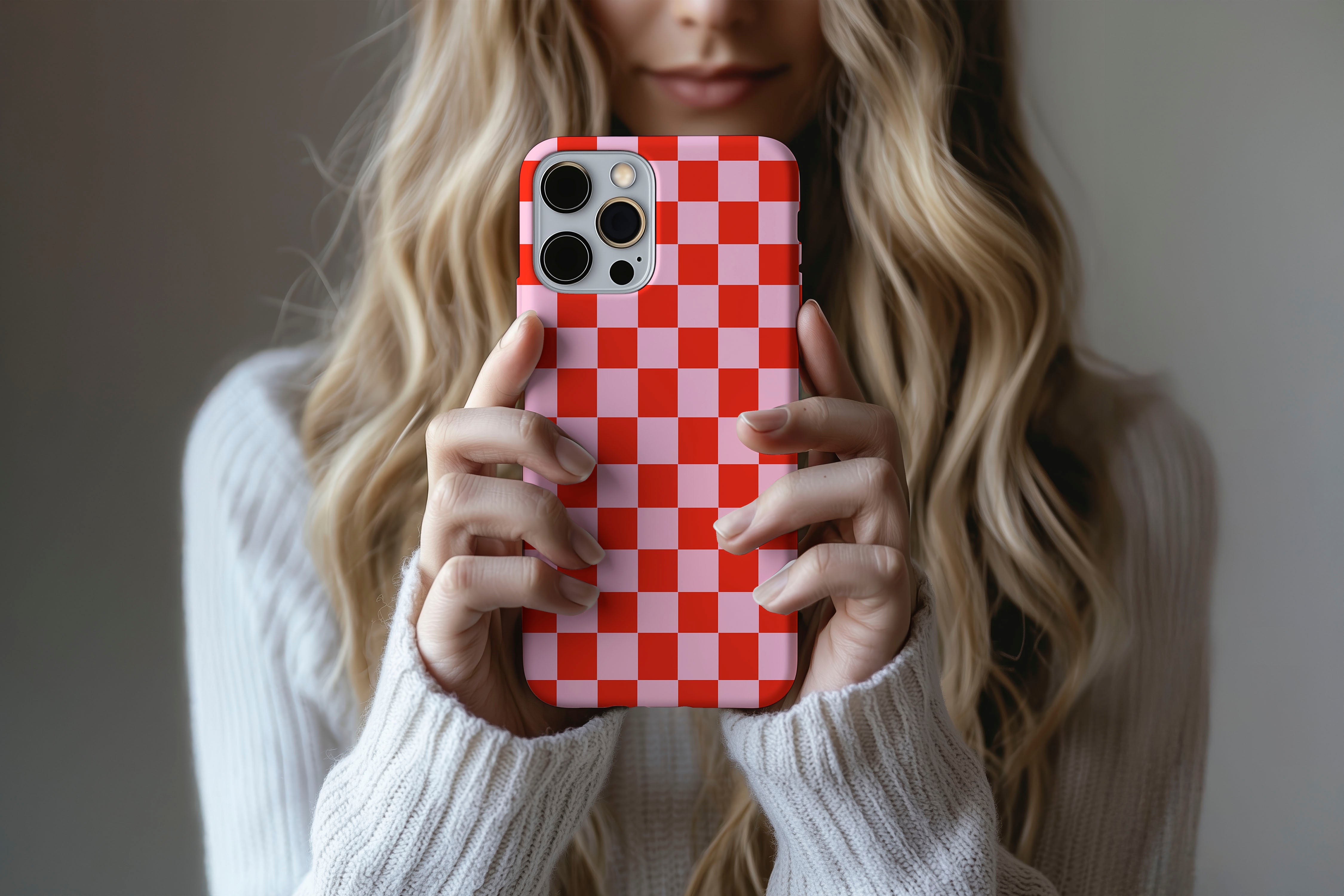 A cute girl holding a phone case featuring our Fit Check design