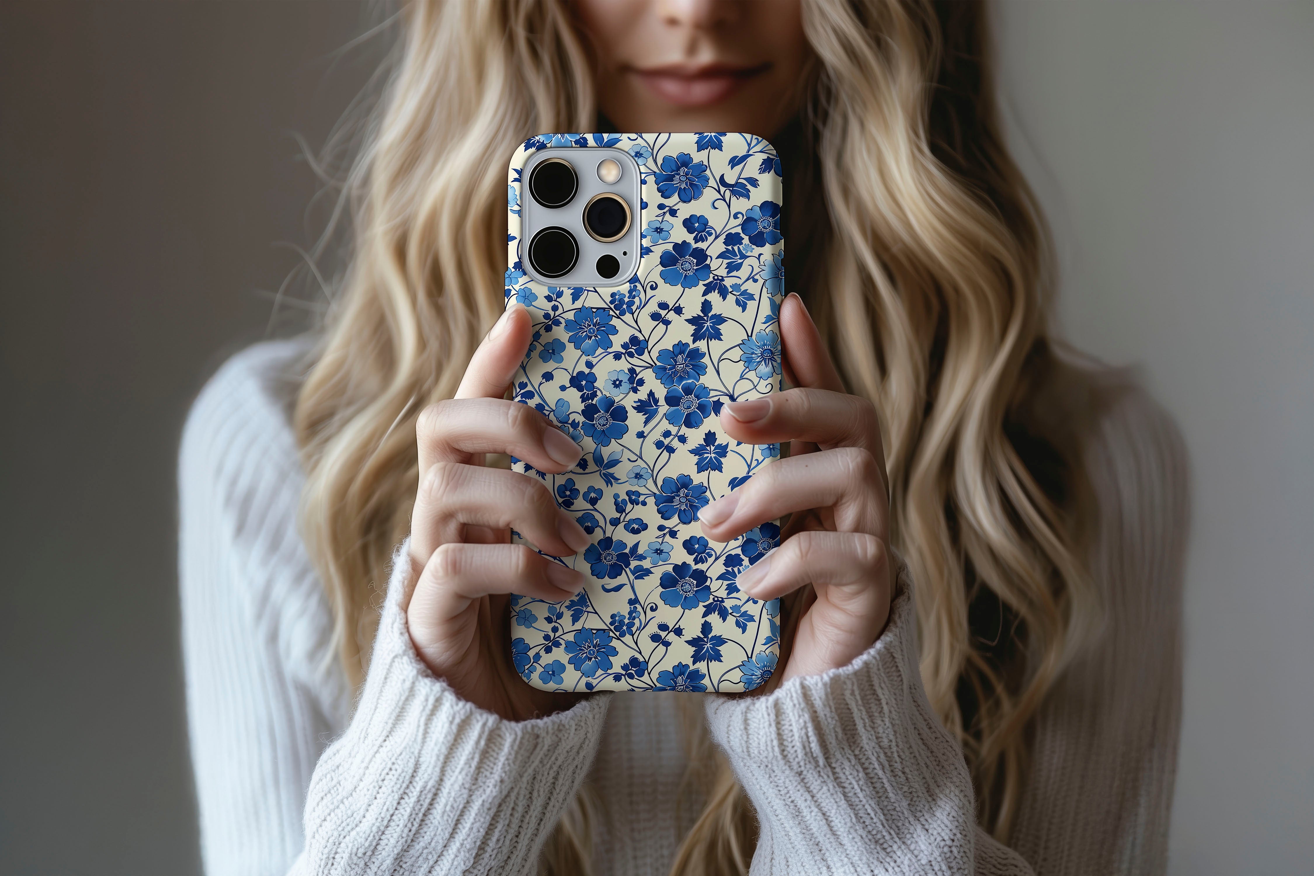 A cute girl holding a phone case featuring our Floral Blues design