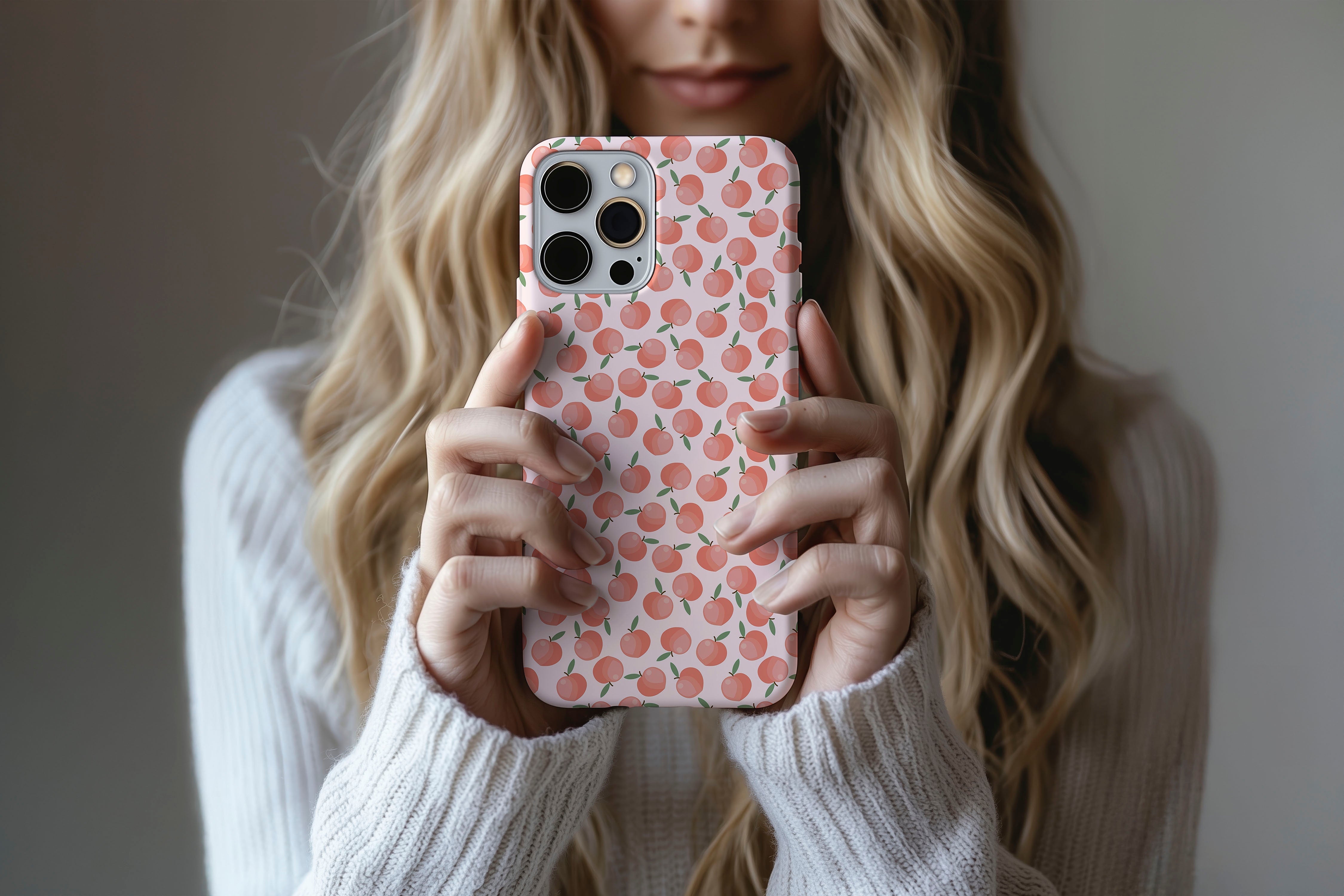 A cute girl holding a phone case featuring our Just Peachy design