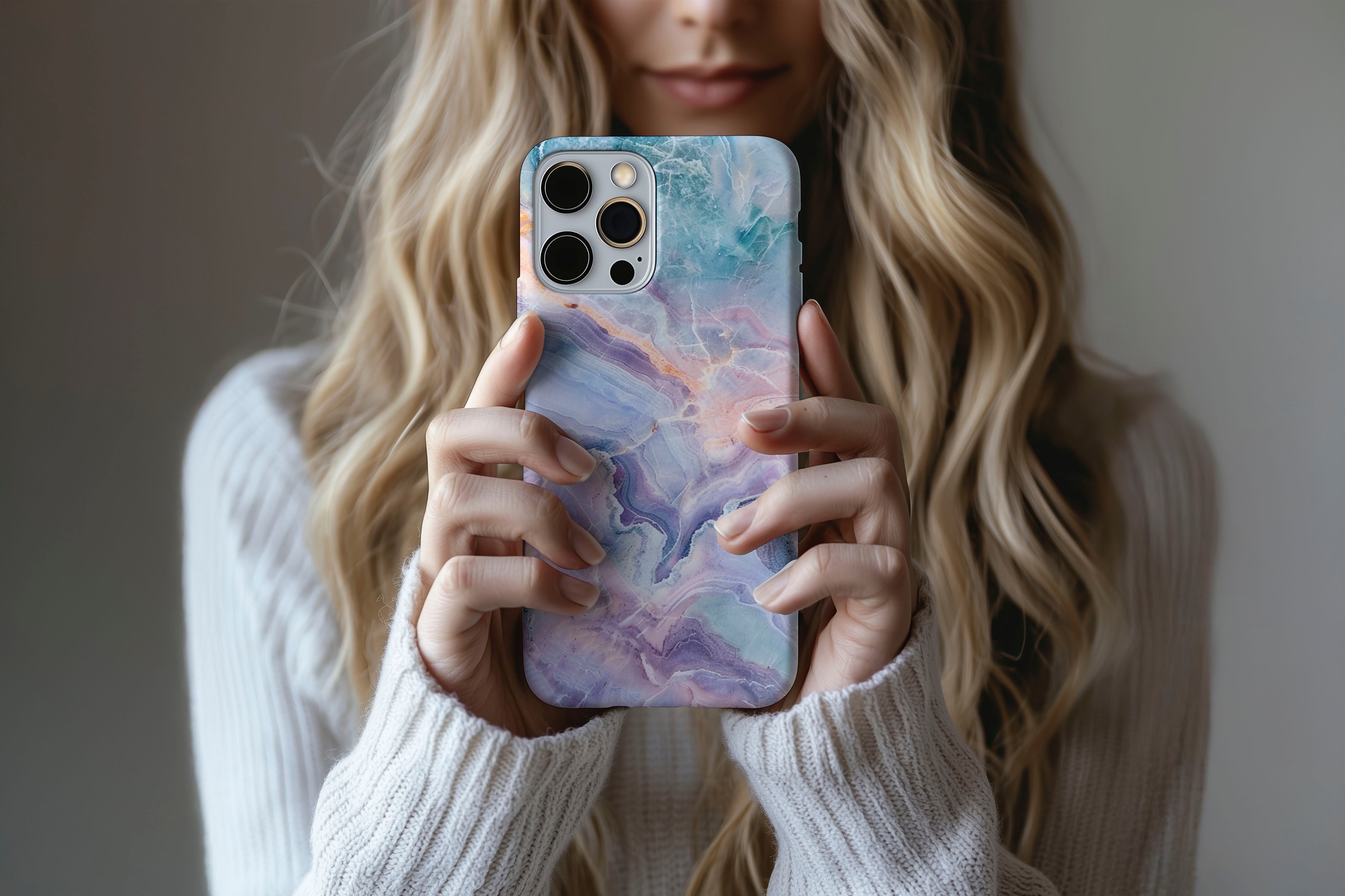 A cute girl holding a phone case featuring our Lost Marble design