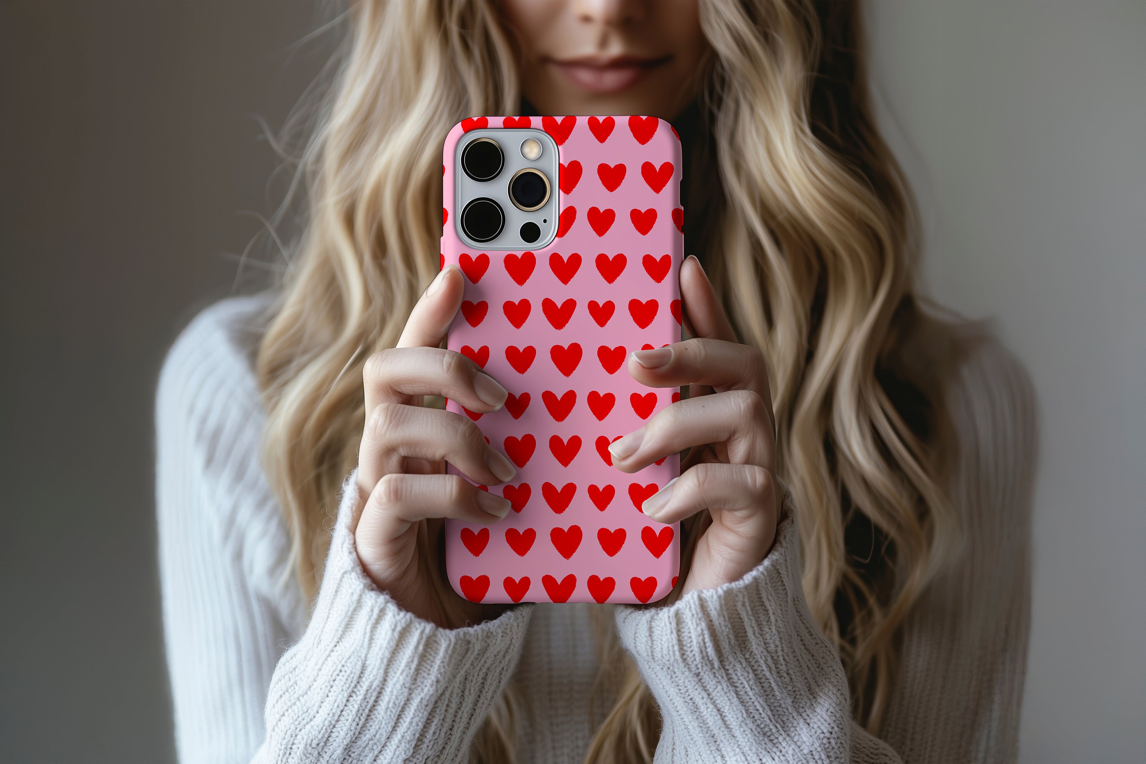 A cute girl holding a phone case featuring our Love design
