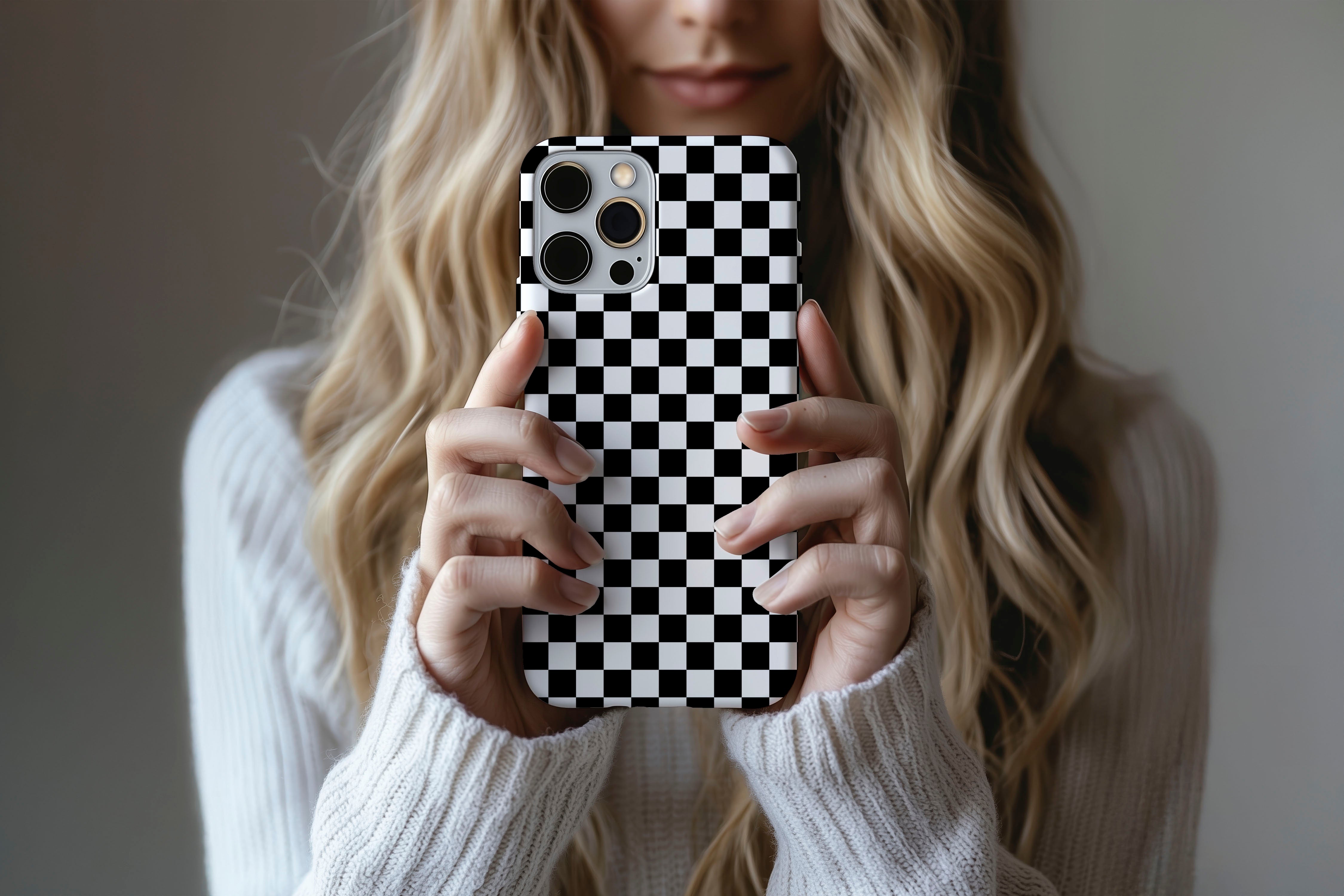 A cute girl holding a phone case featuring our Mono Checkerboard design