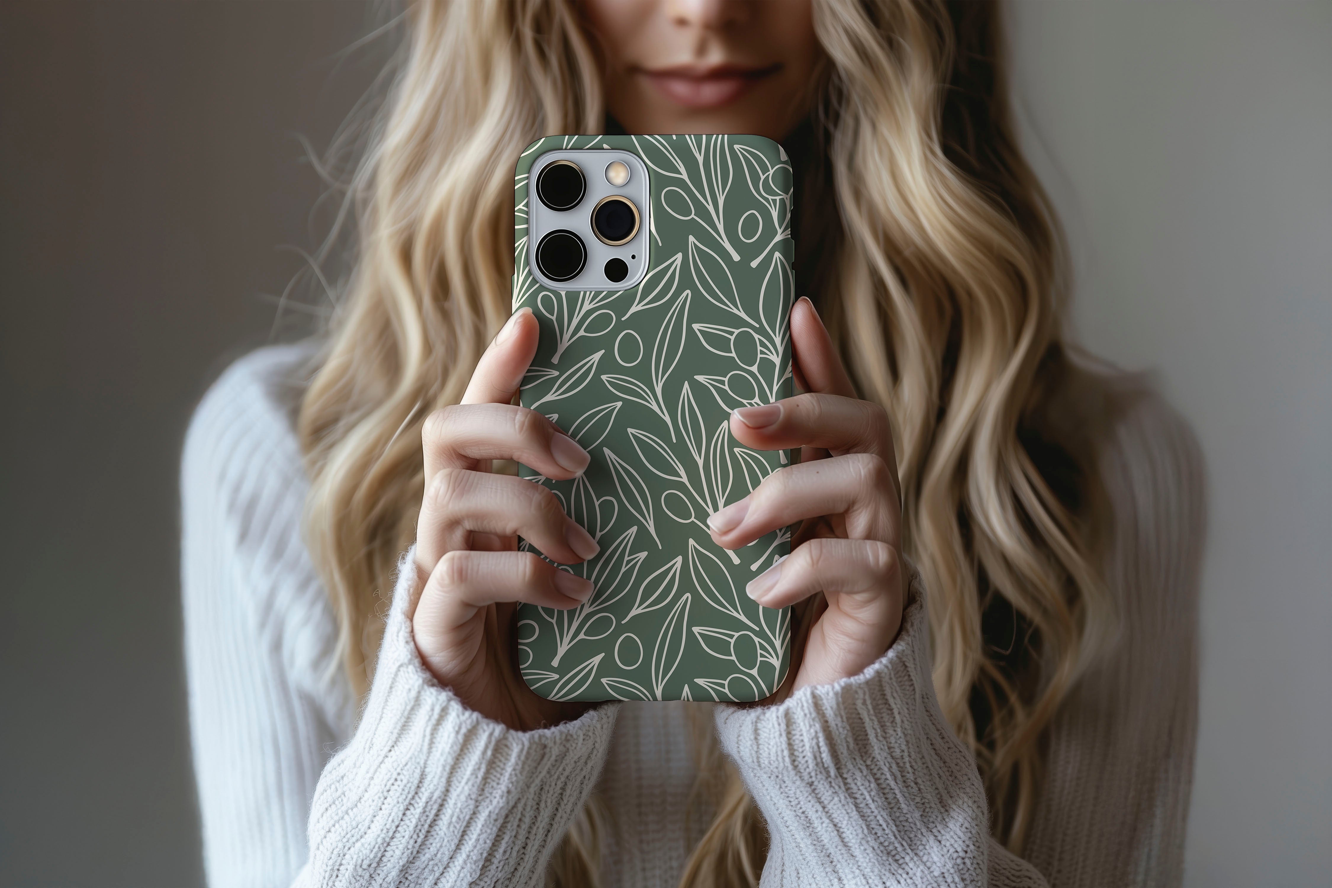 A cute girl holding a phone case featuring our Olive Leaf design