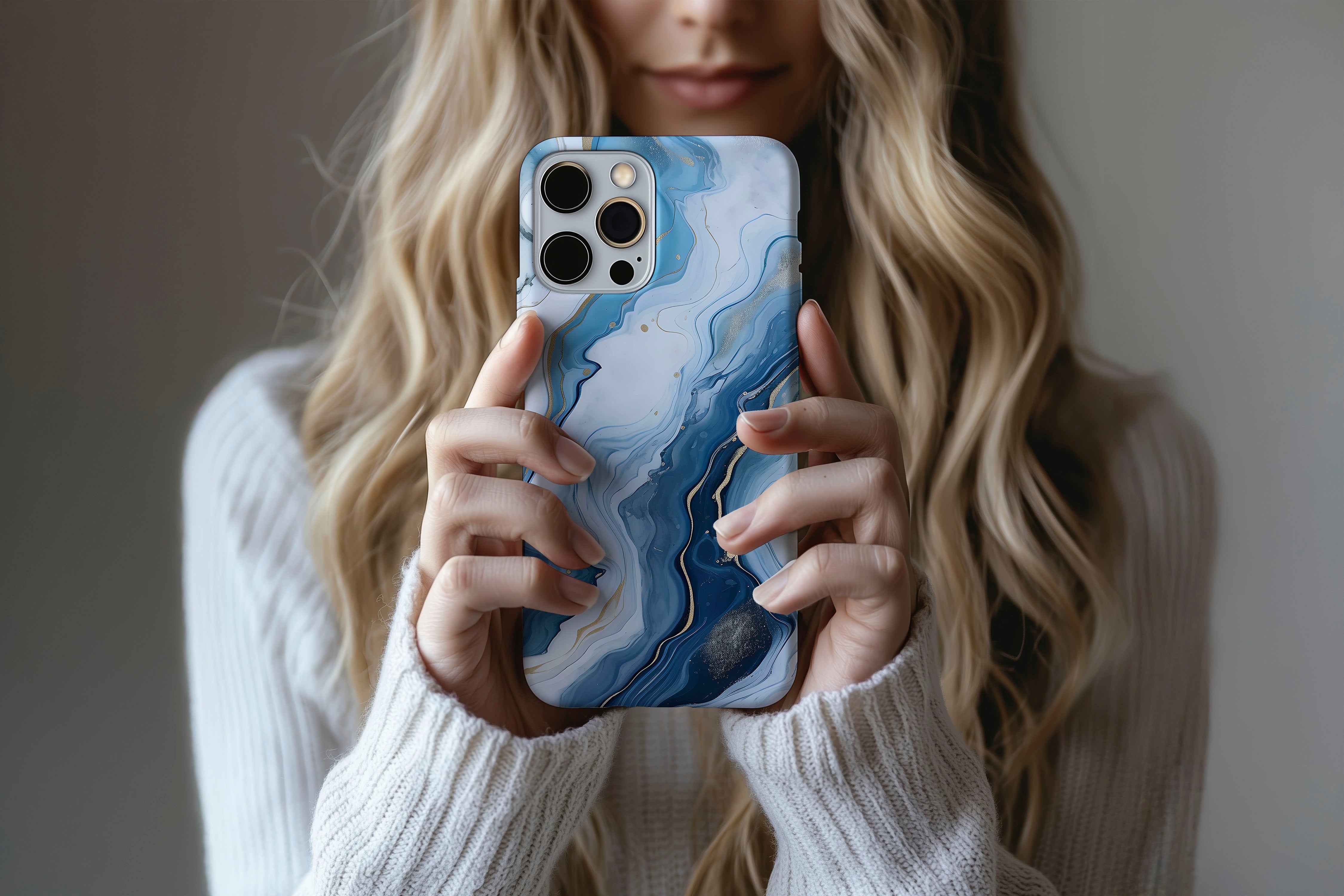 A cute girl holding a phone case featuring our Opulent Blue design