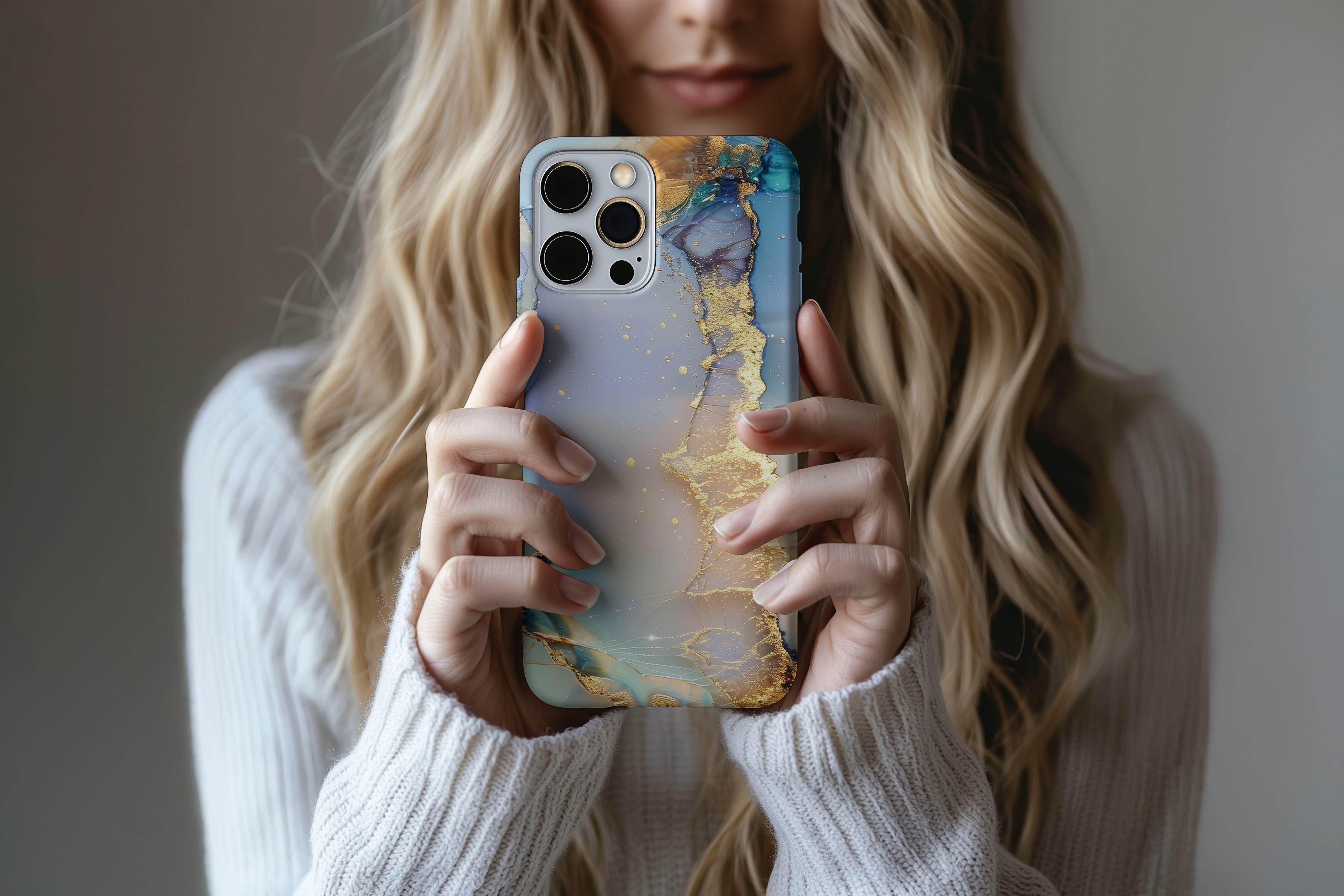 A cute girl holding a phone case featuring our Opulent Marble design