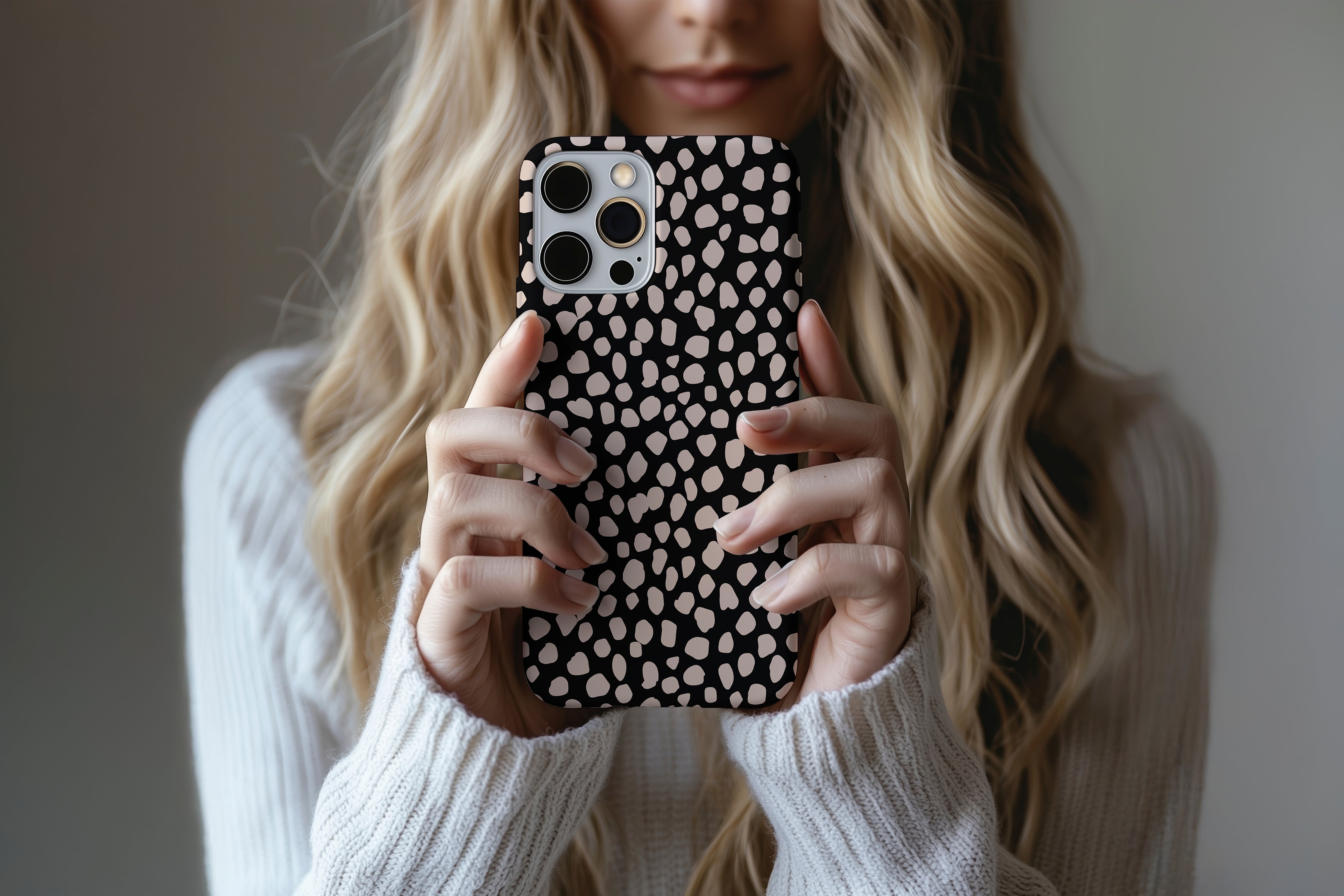 A cute girl holding a phone case featuring our Pebbles design