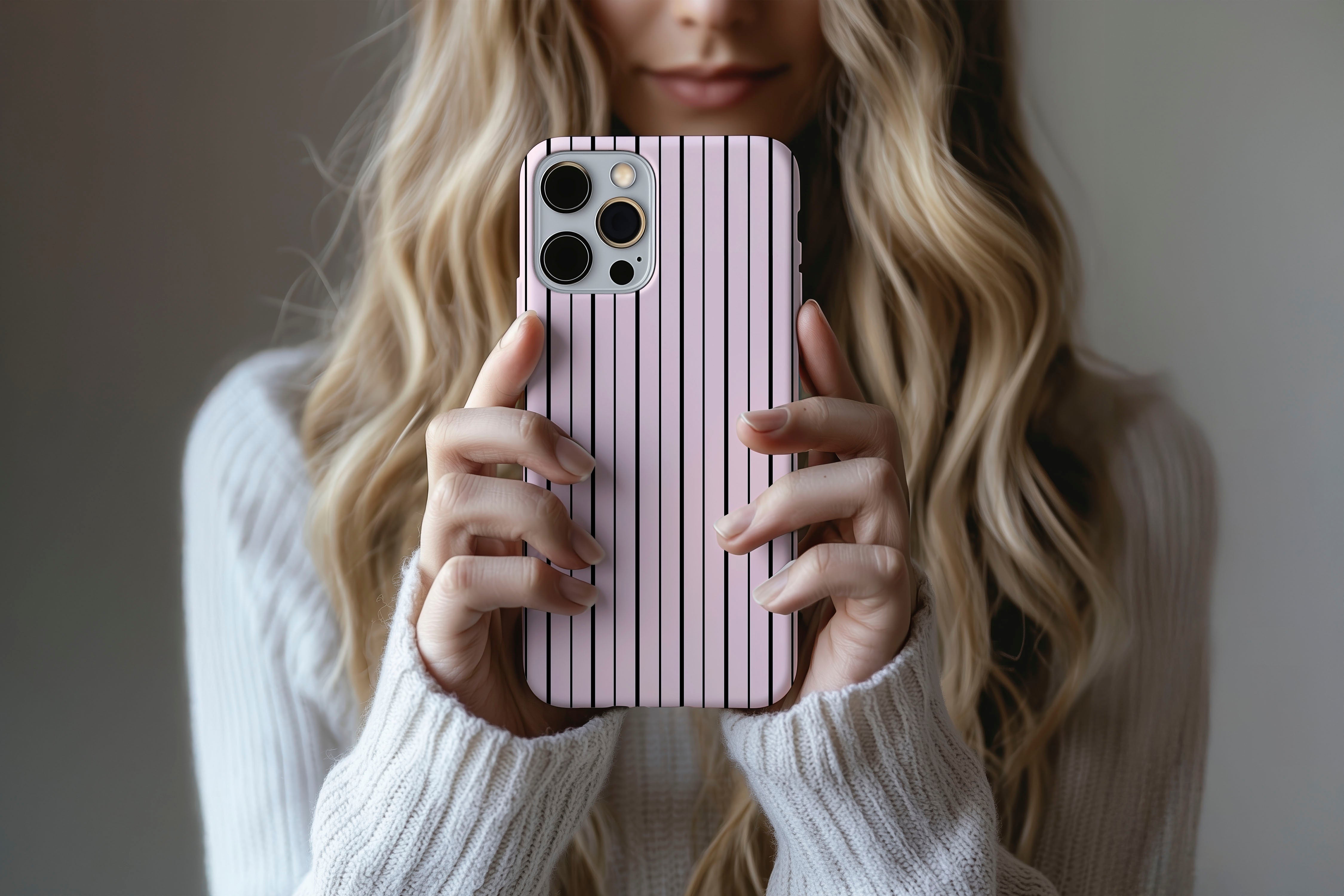 A cute girl holding a phone case featuring our Pillow Talk design