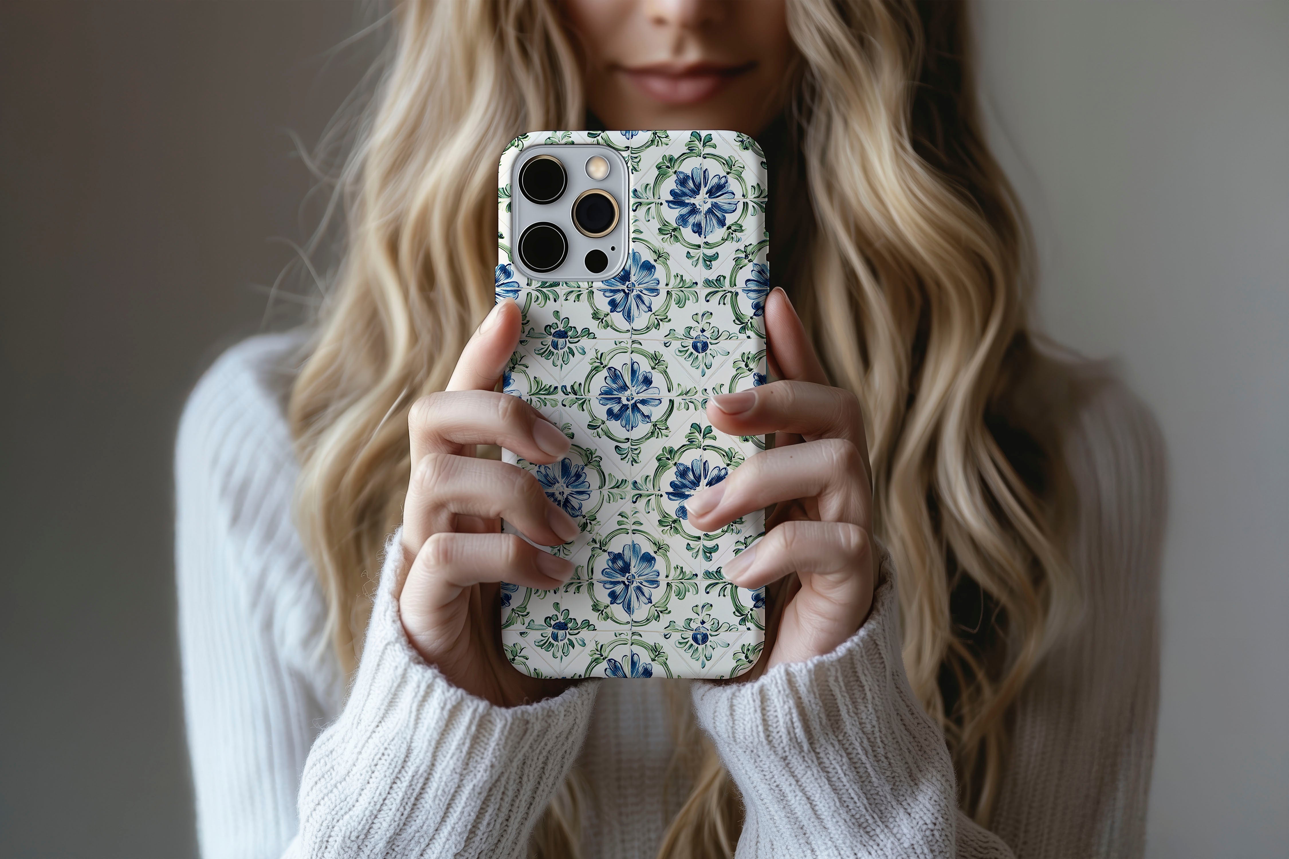 A cute girl holding a phone case featuring our Pretty Tile design
