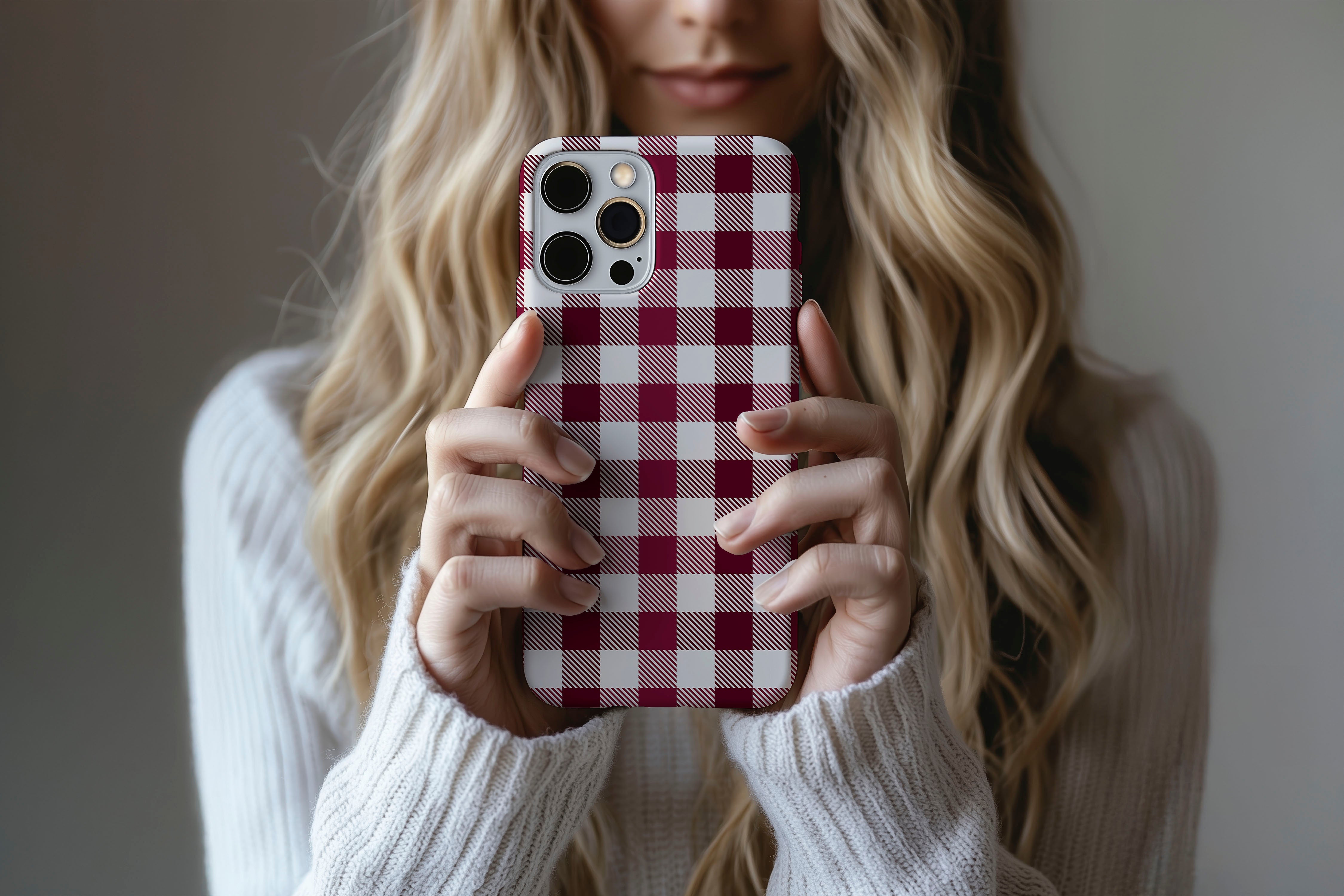 A cute girl holding a phone case featuring our Red Check design