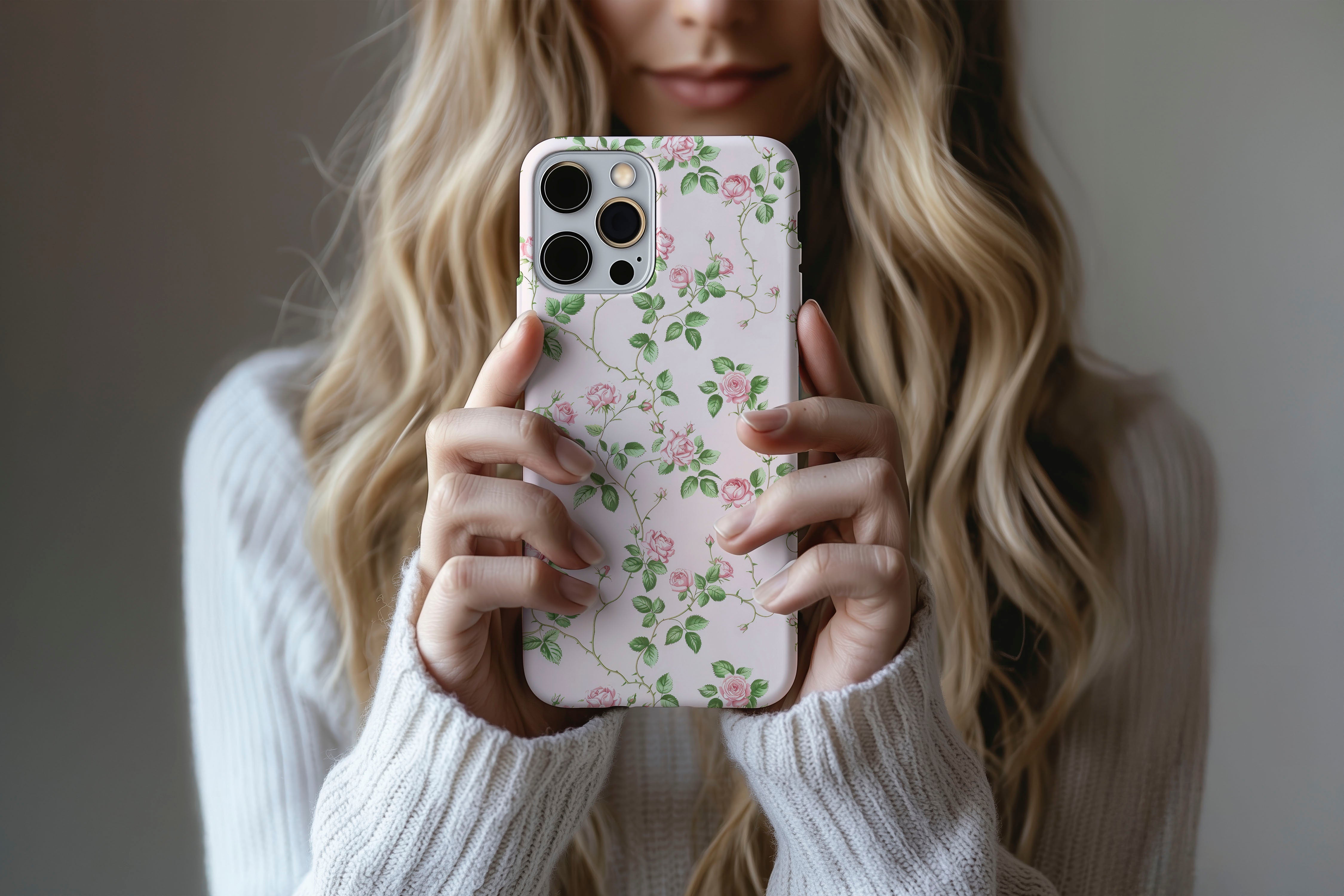 A cute girl holding a phone case featuring our Rose Bush design