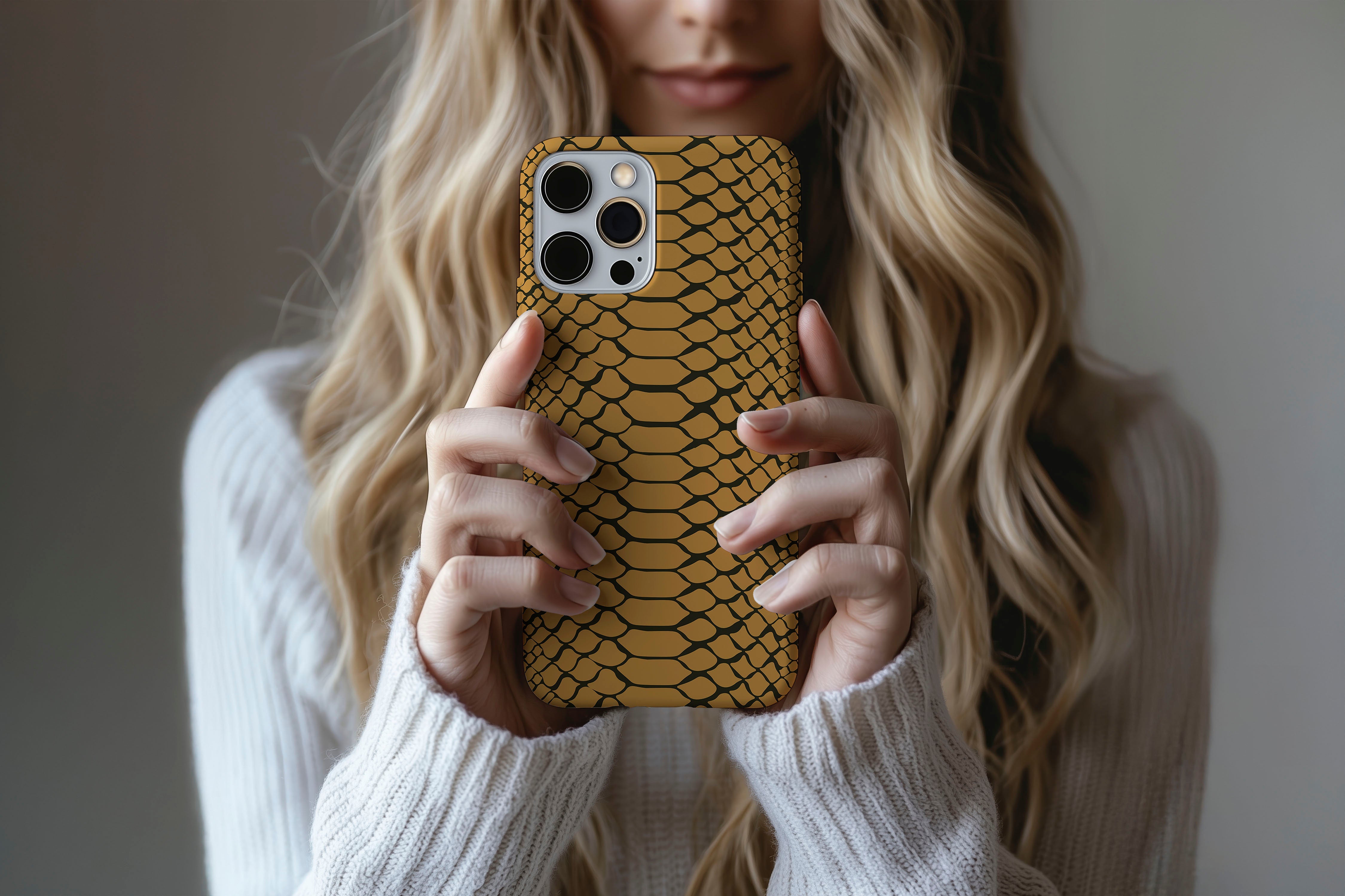 A cute girl holding a phone case featuring our Scaled Up design