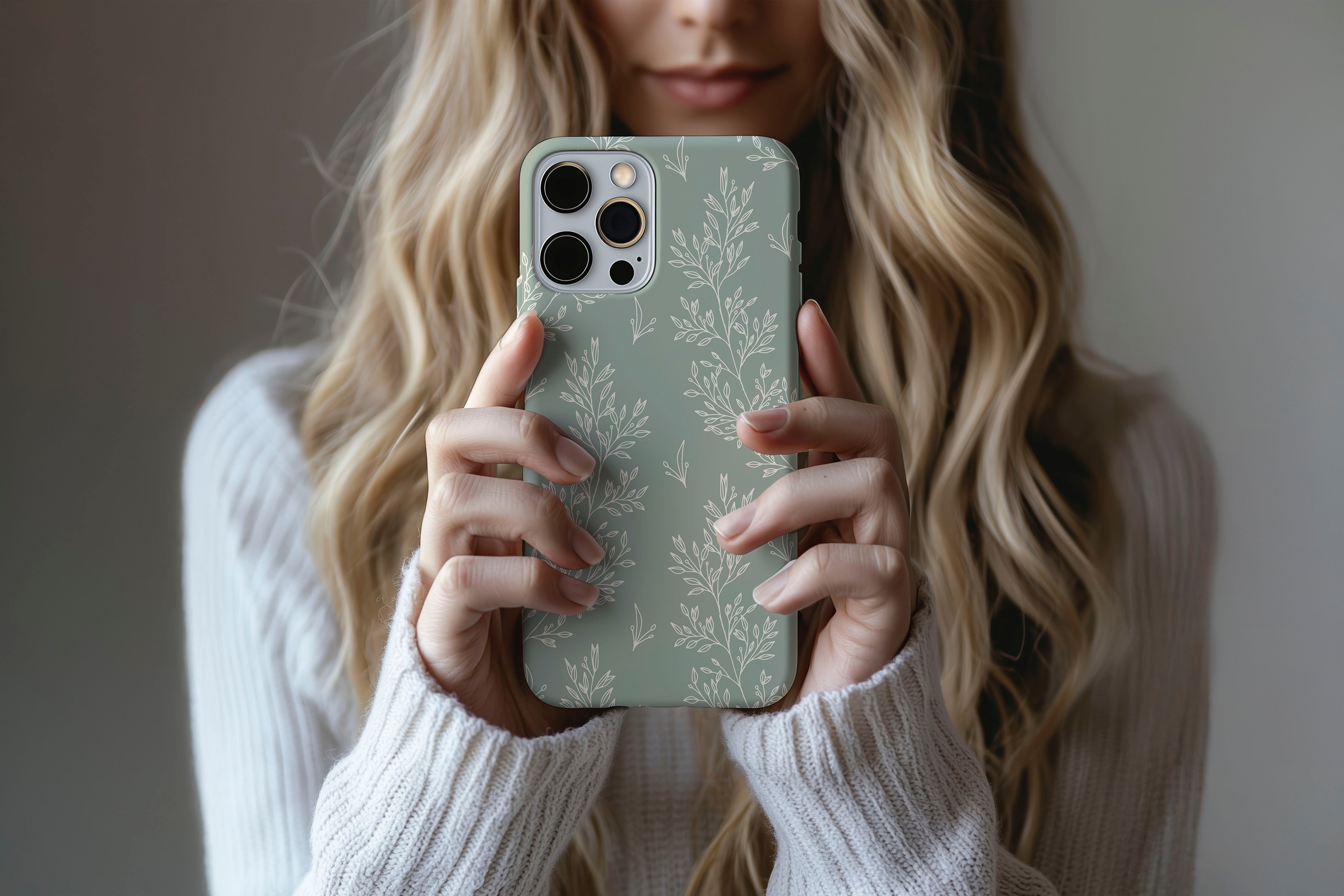 A cute girl holding a phone case featuring our Soft Green design