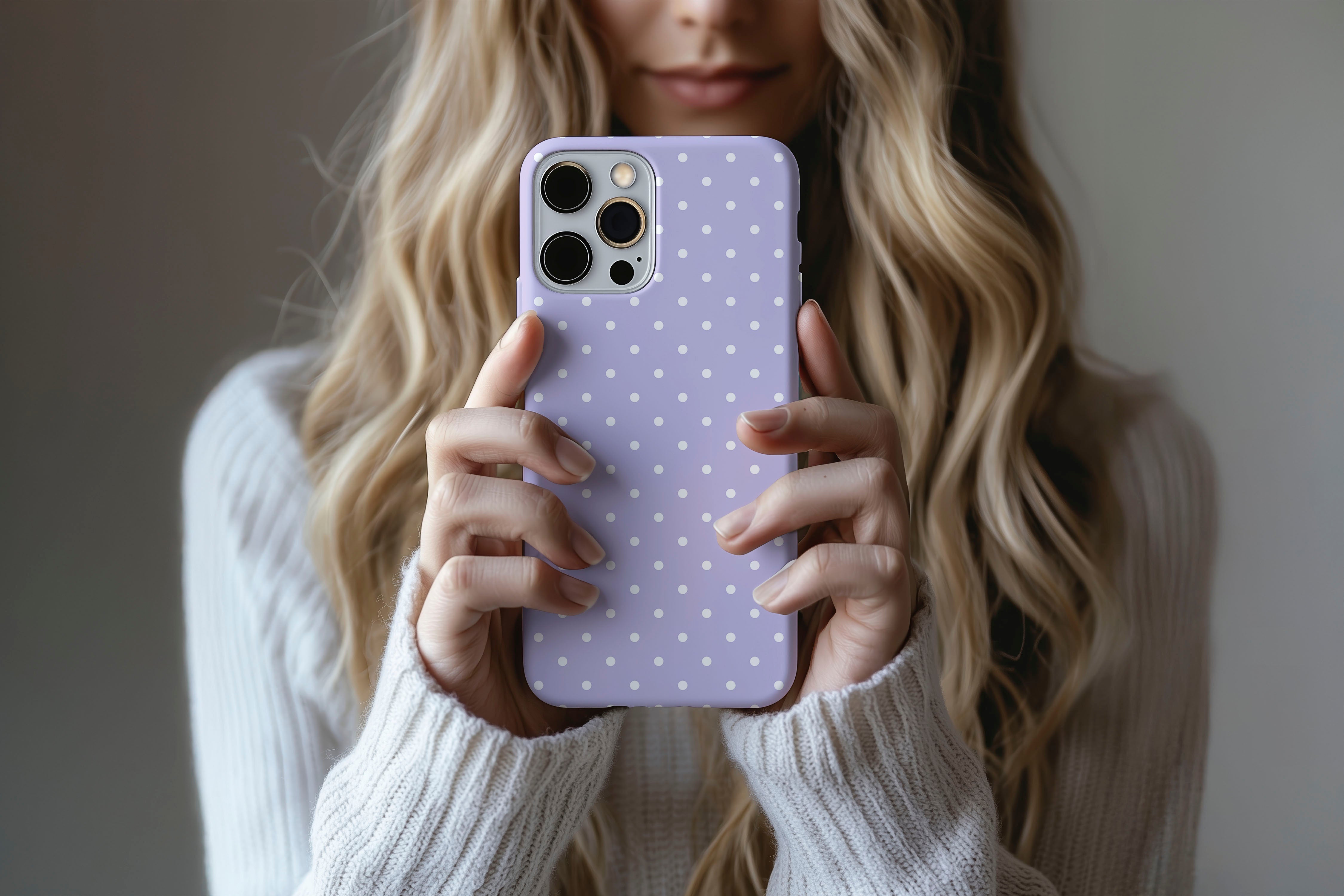 A cute girl holding a phone case featuring our Spotted Lilac design