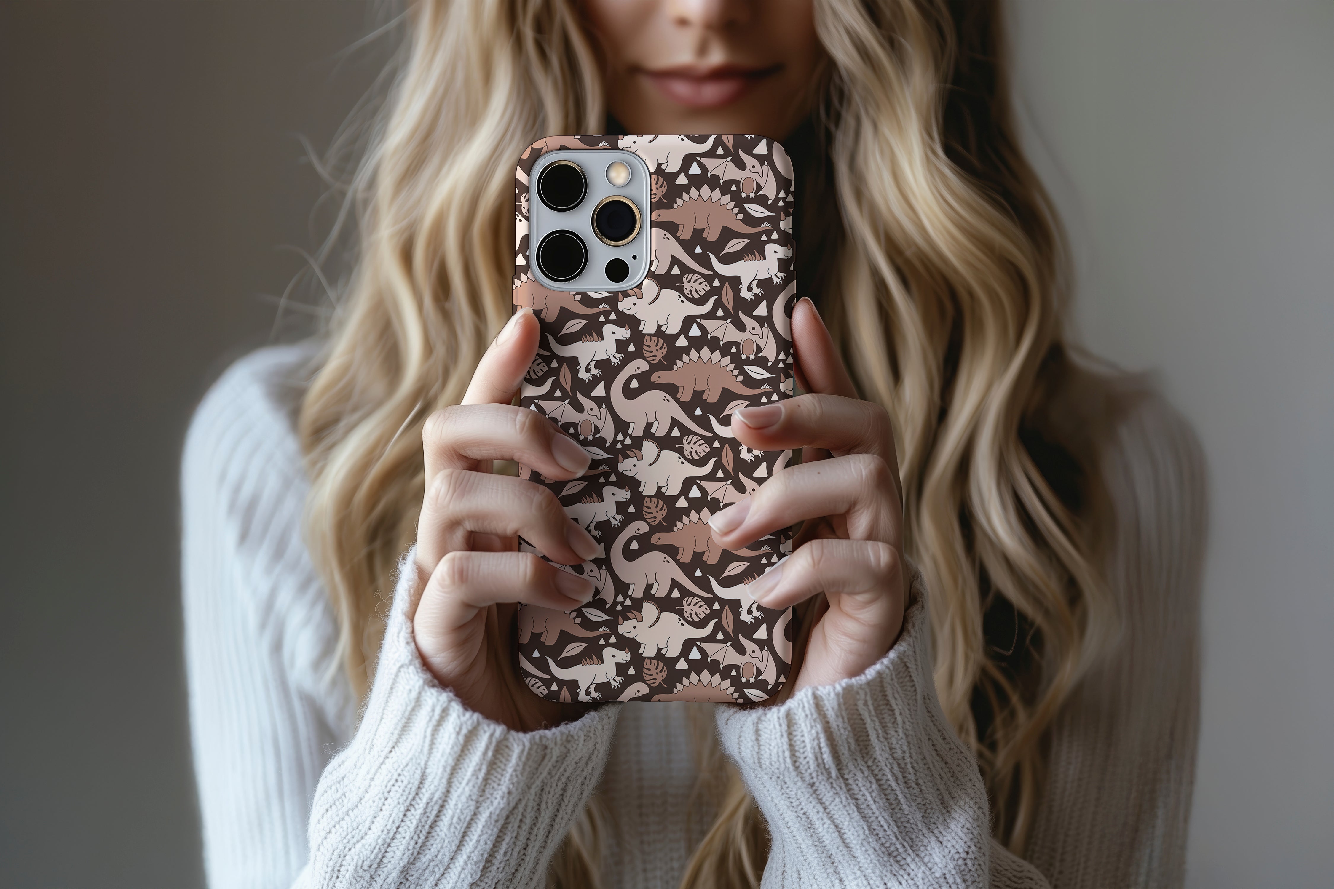 A cute girl holding a phone case featuring our Subtle Dino design