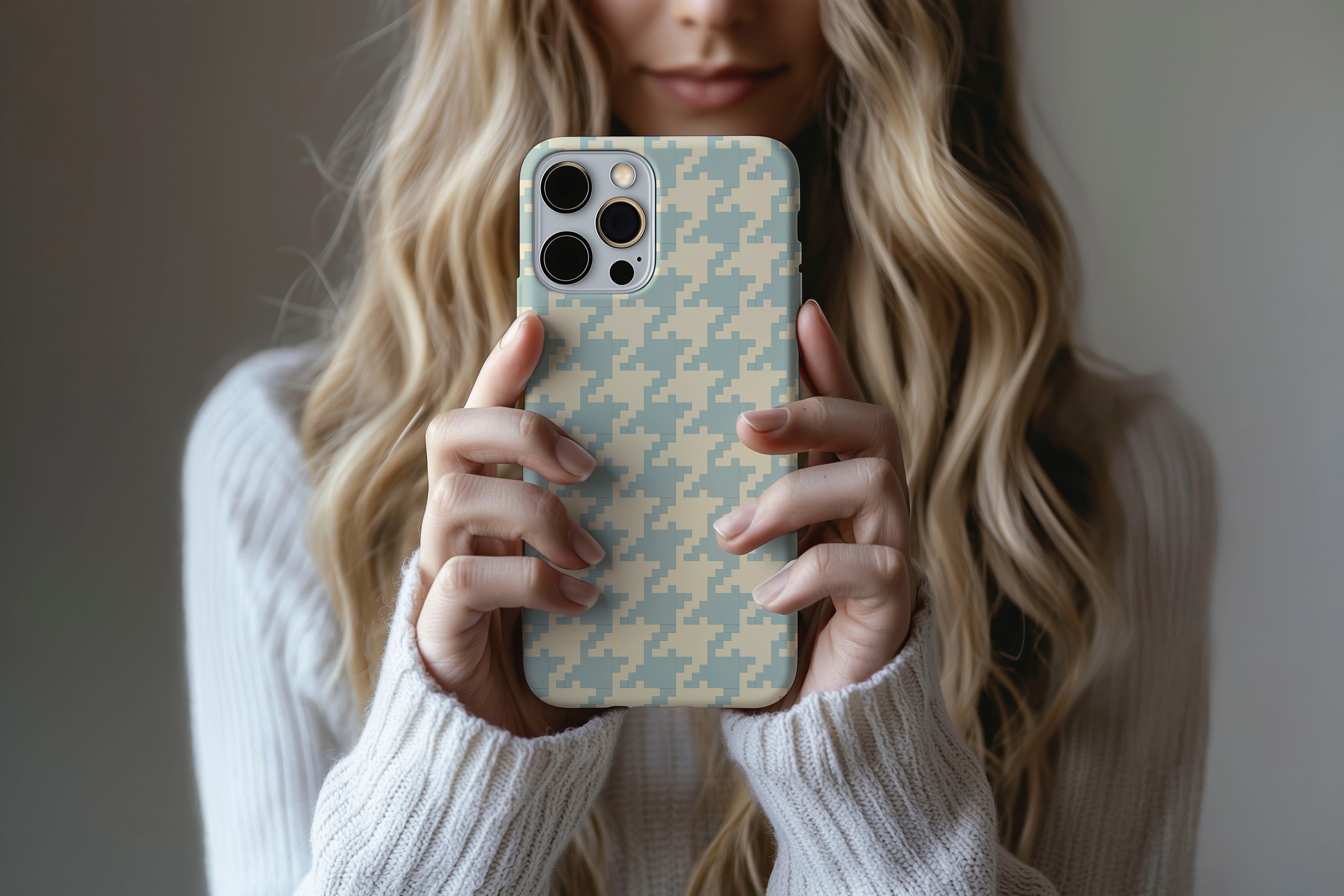 A cute girl holding a phone case featuring our Subtle Houndstooth design