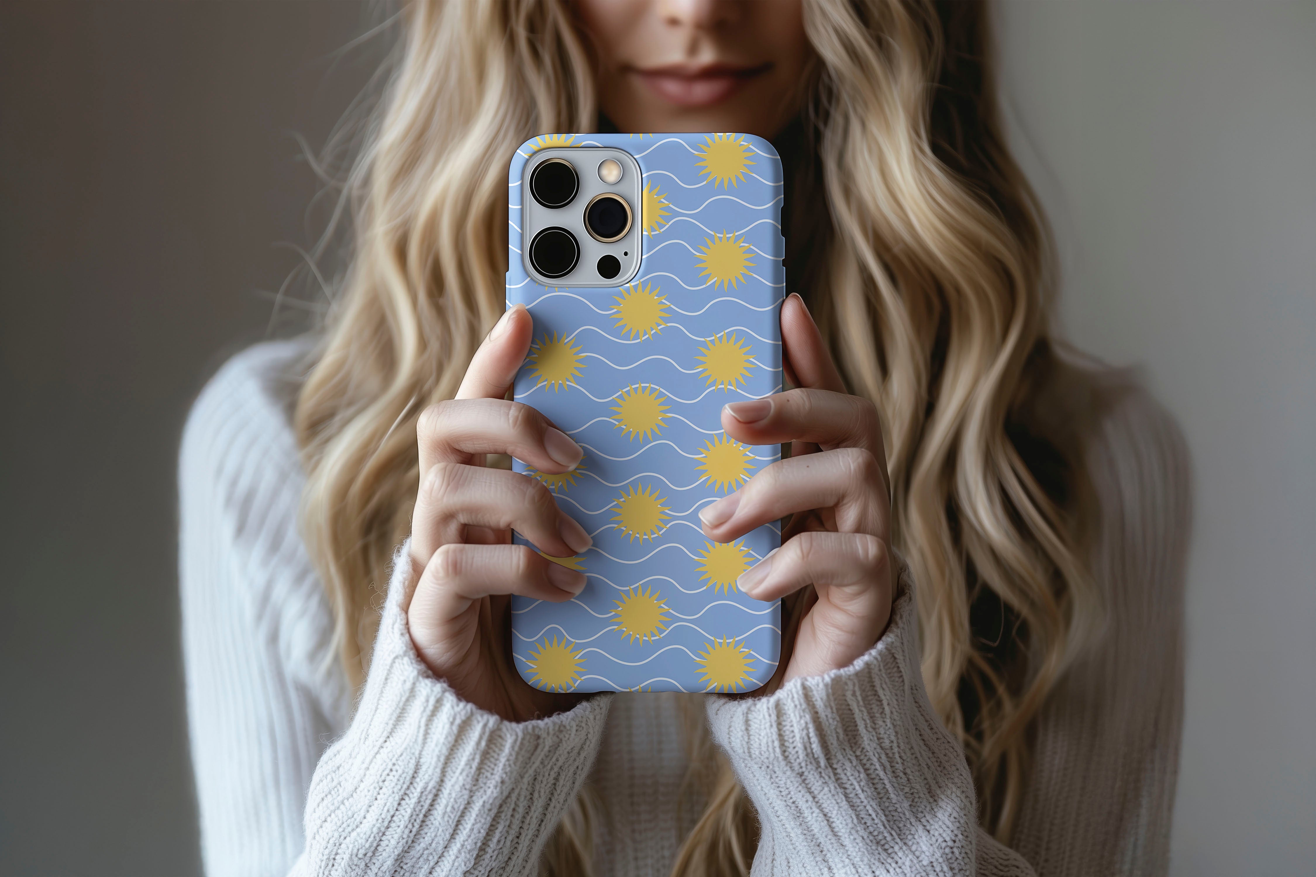 A cute girl holding a phone case featuring our Sun Stroke design