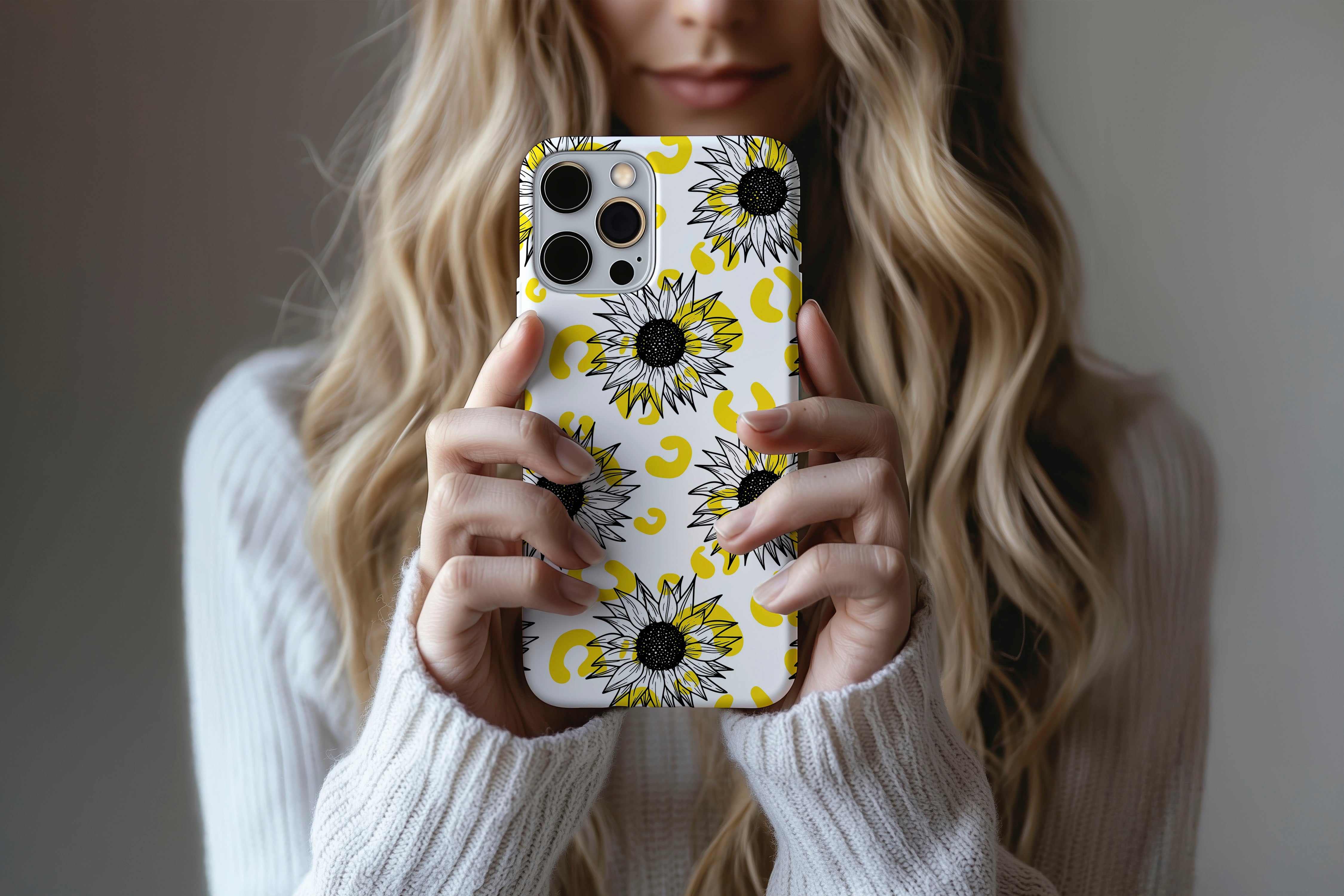 A cute girl holding a phone case featuring our Sunflowers design