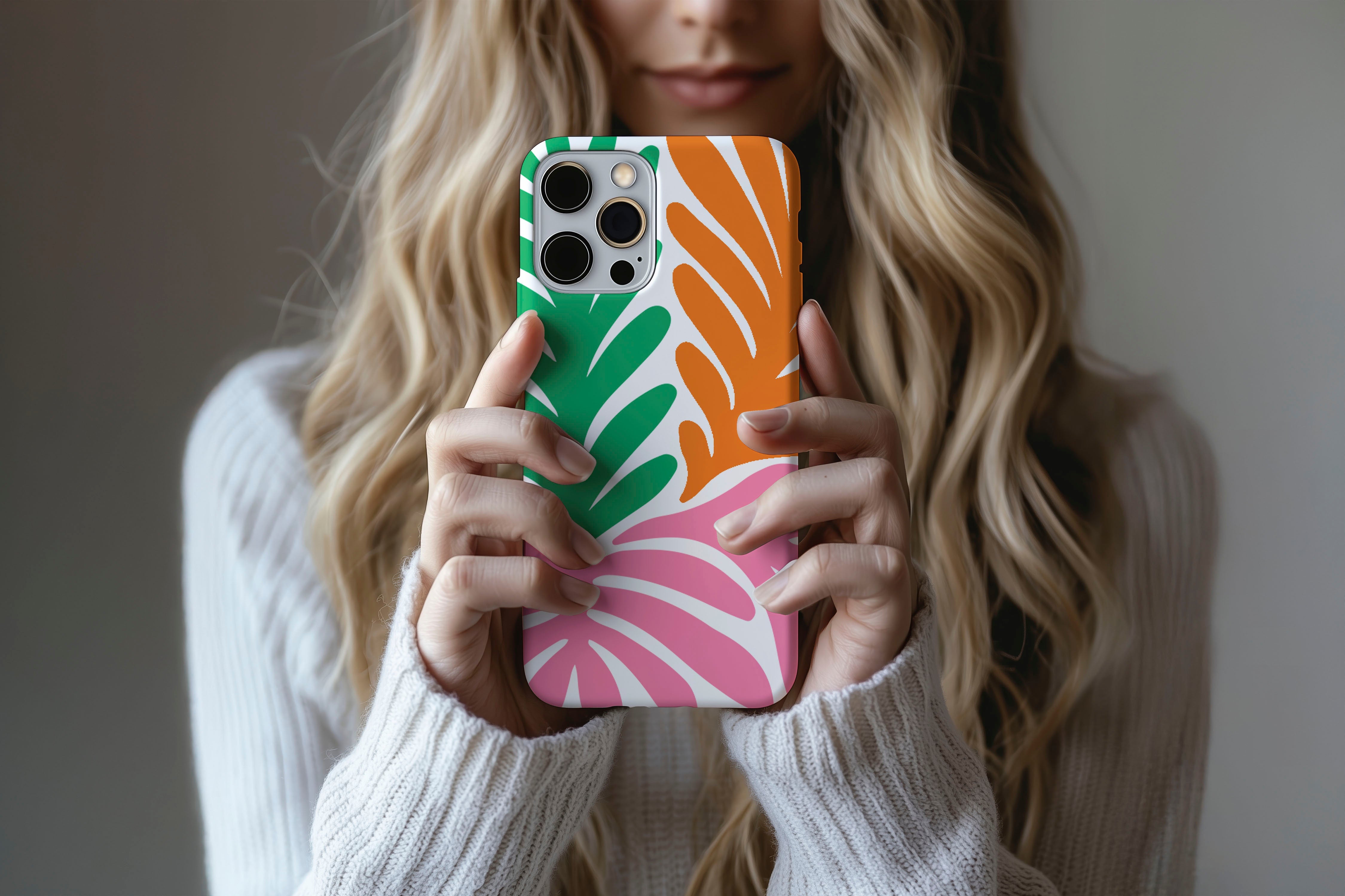 A cute girl holding a phone case featuring our Sunset Palm design