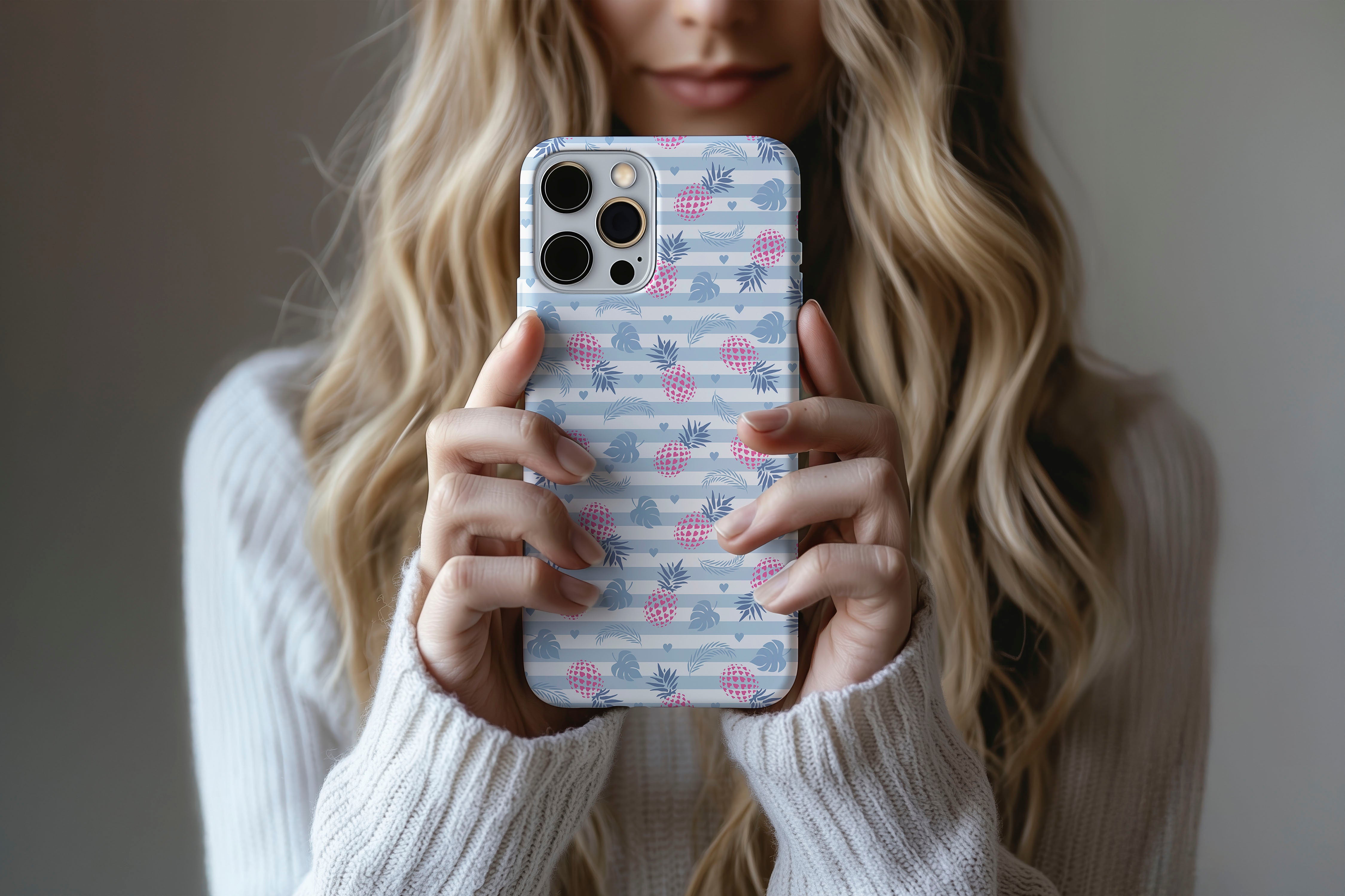 A cute girl holding a phone case featuring our Tropical Taste design