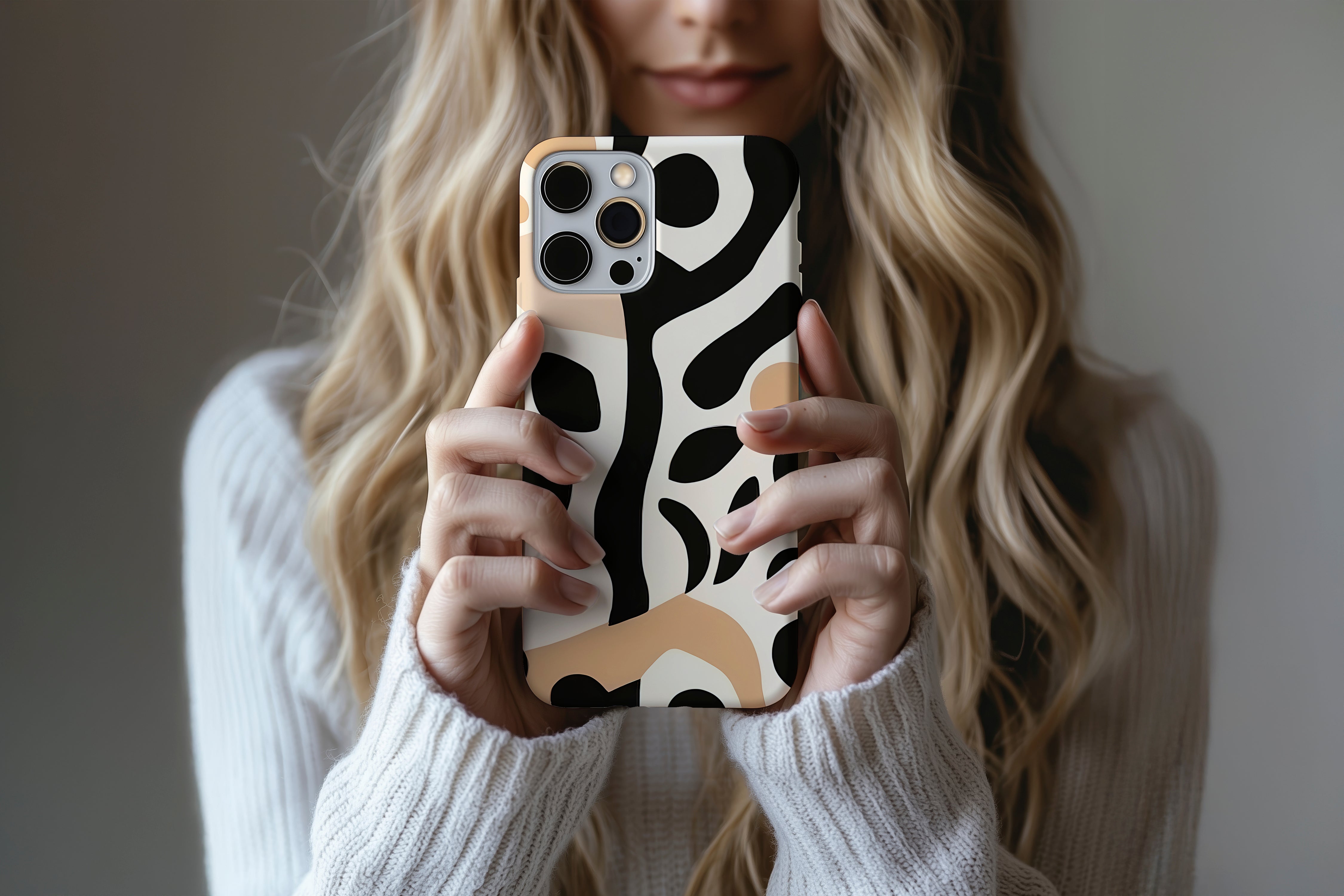 A cute girl holding a phone case featuring our Abstract Jungle  design