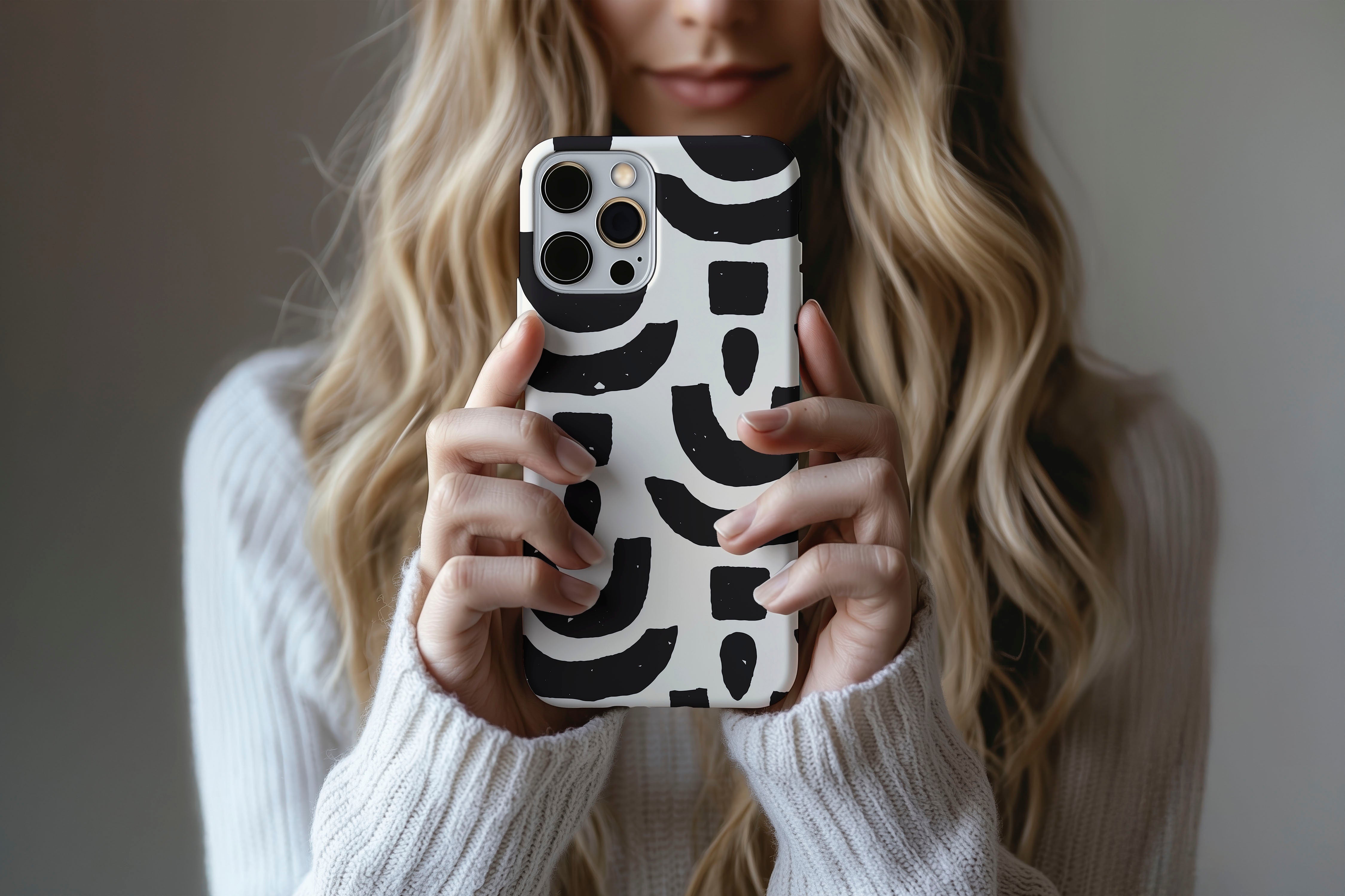 A cute girl holding a phone case featuring our Abstract Shapes design