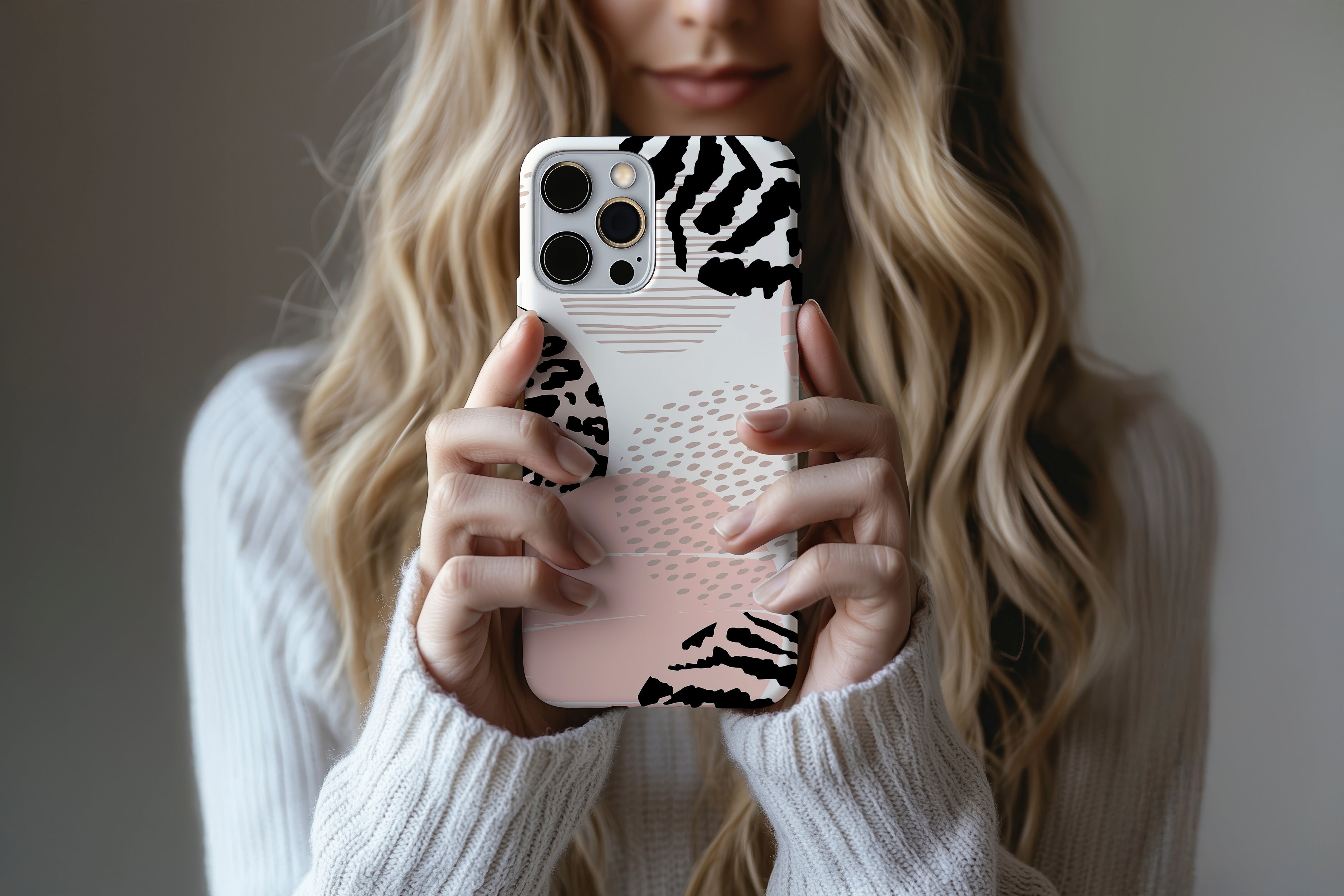 A cute girl holding a phone case featuring our Animal Kingdom  design