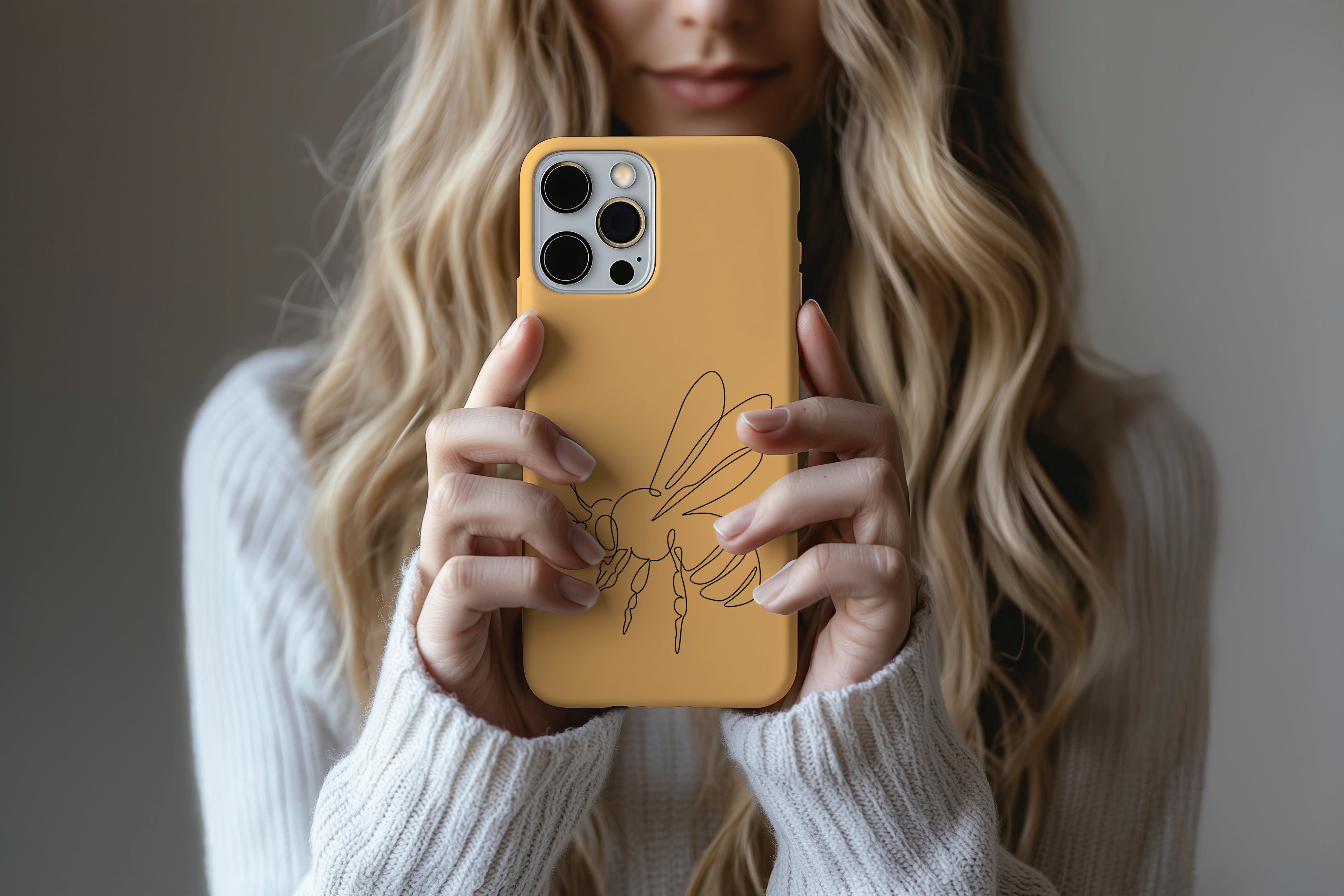 A cute girl holding a phone case featuring our Artful Bee  design