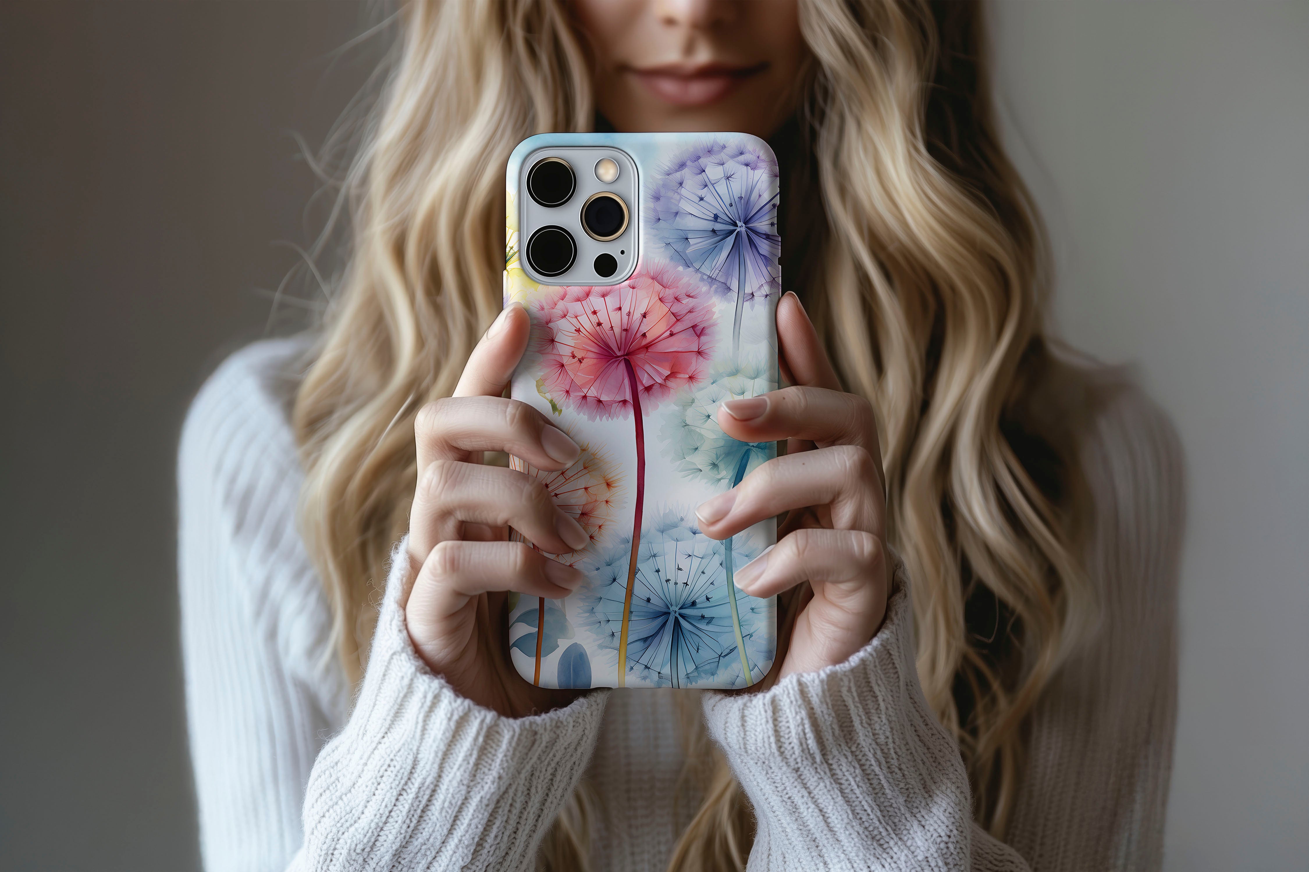 A cute girl holding a phone case featuring our Dandelion Dream design