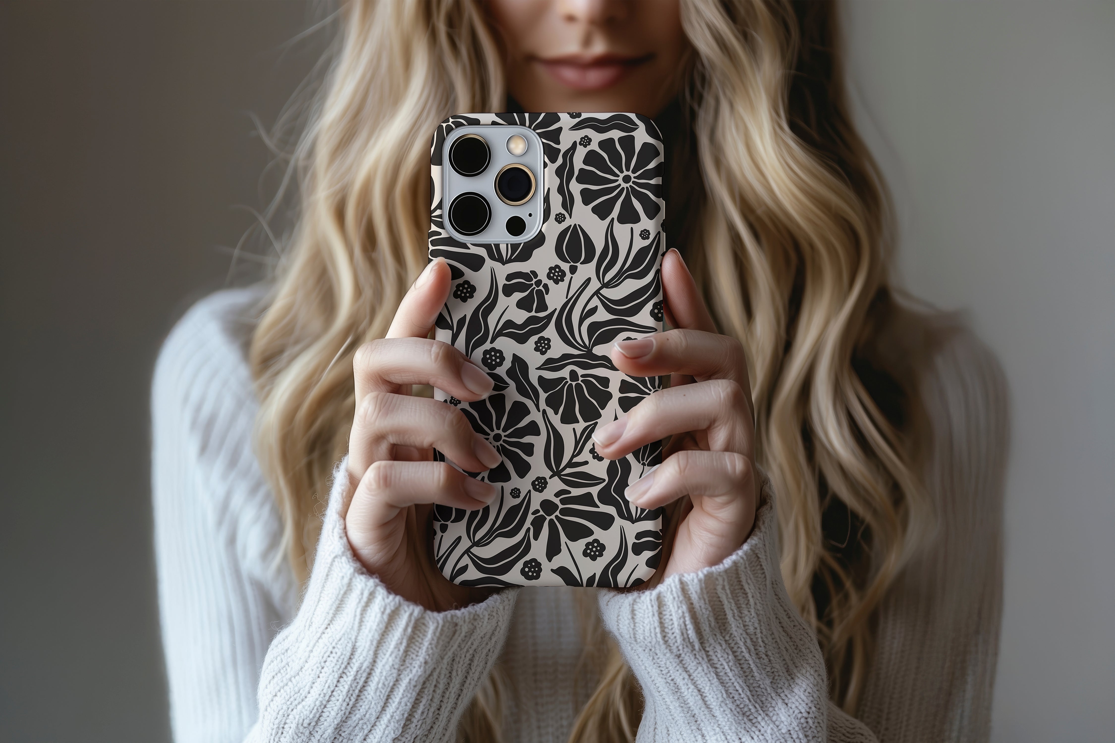 A cute girl holding a phone case featuring our Dark Flower  design