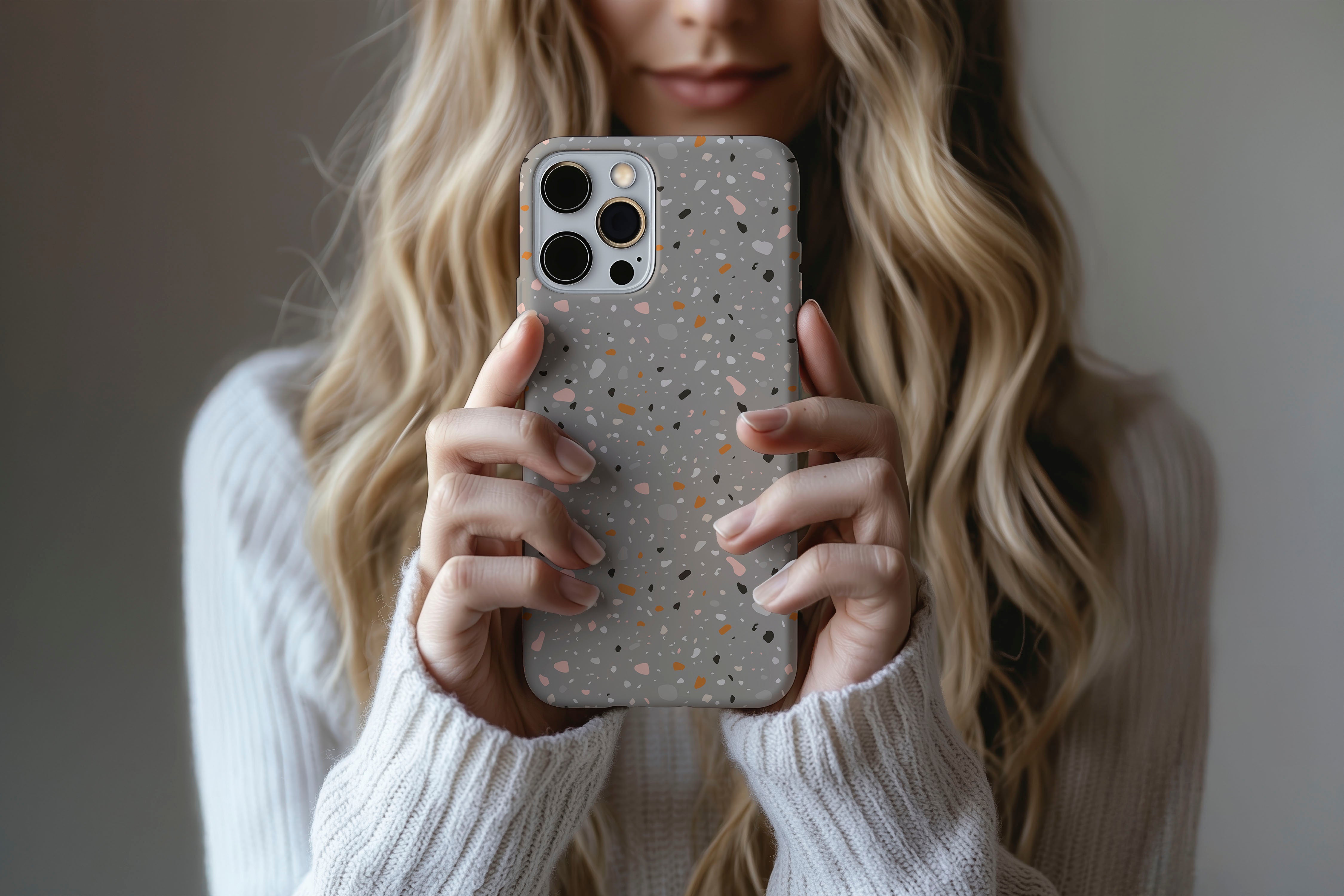 A cute girl holding a phone case featuring our Dark Mosaic design
