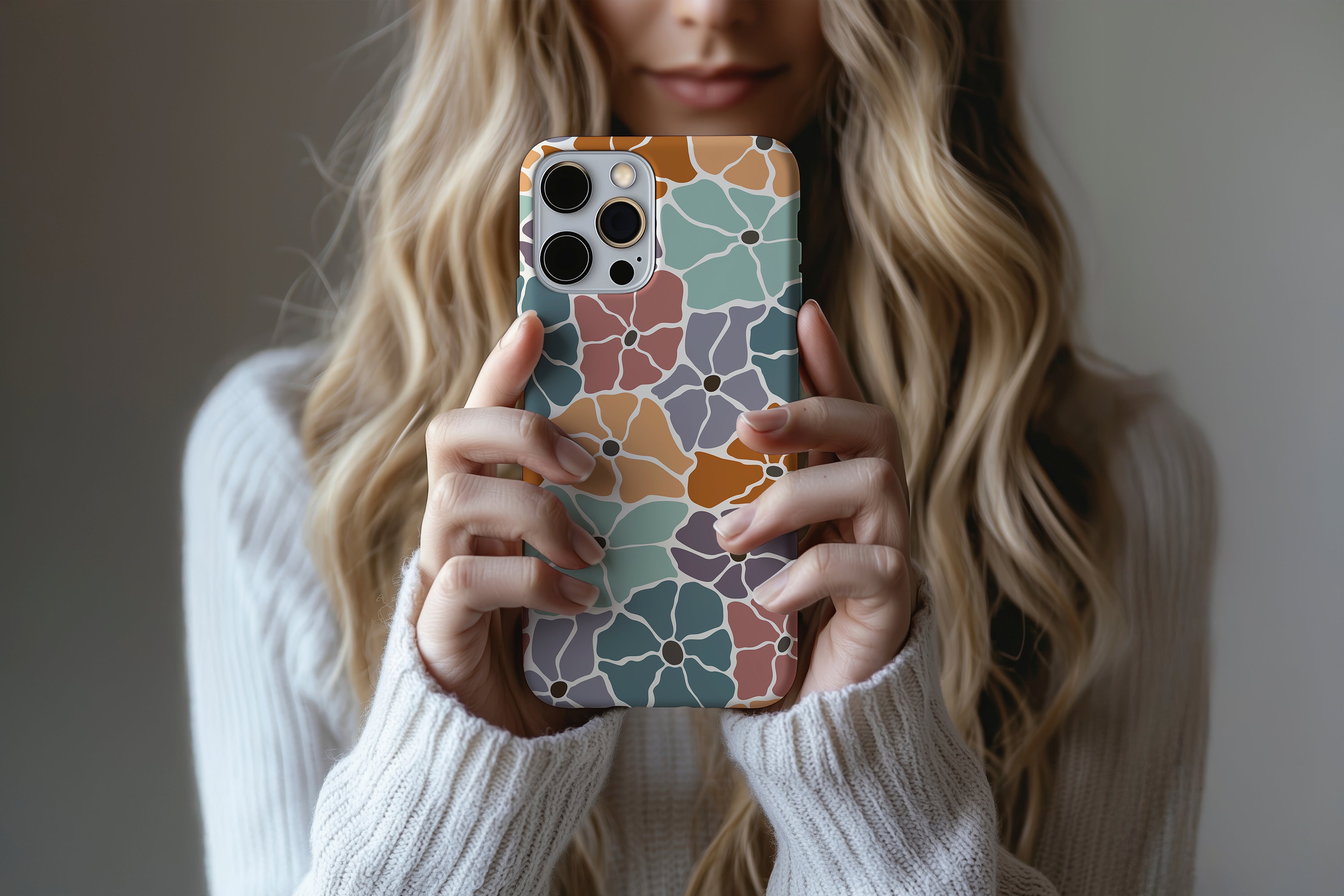 A cute girl holding a phone case featuring our Floral Bunch  design
