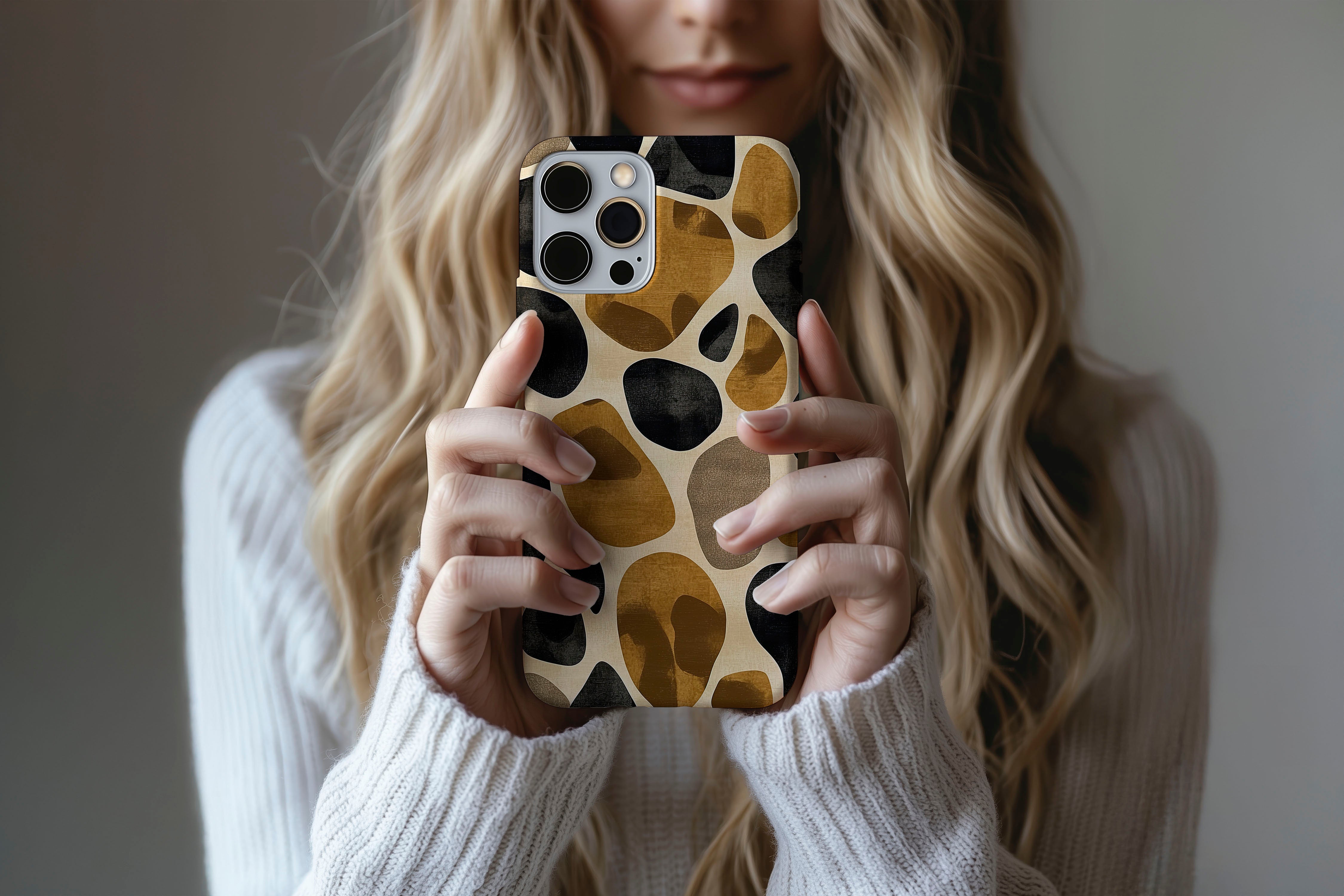 A cute girl holding a phone case featuring our Giraffe design